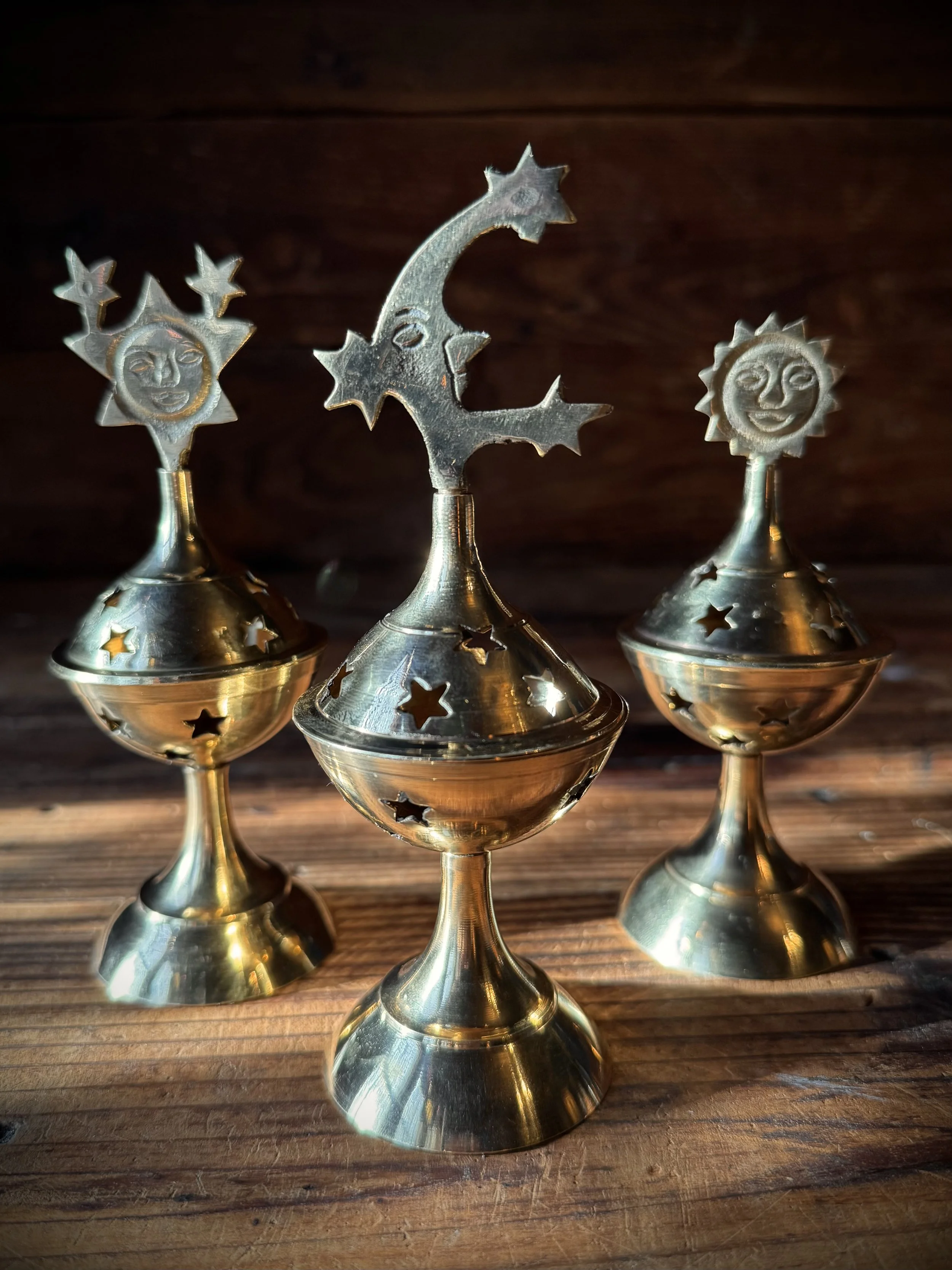brass celestial cone incense burner with a removable top, cutout stars, and sun, moon, or star top decoration