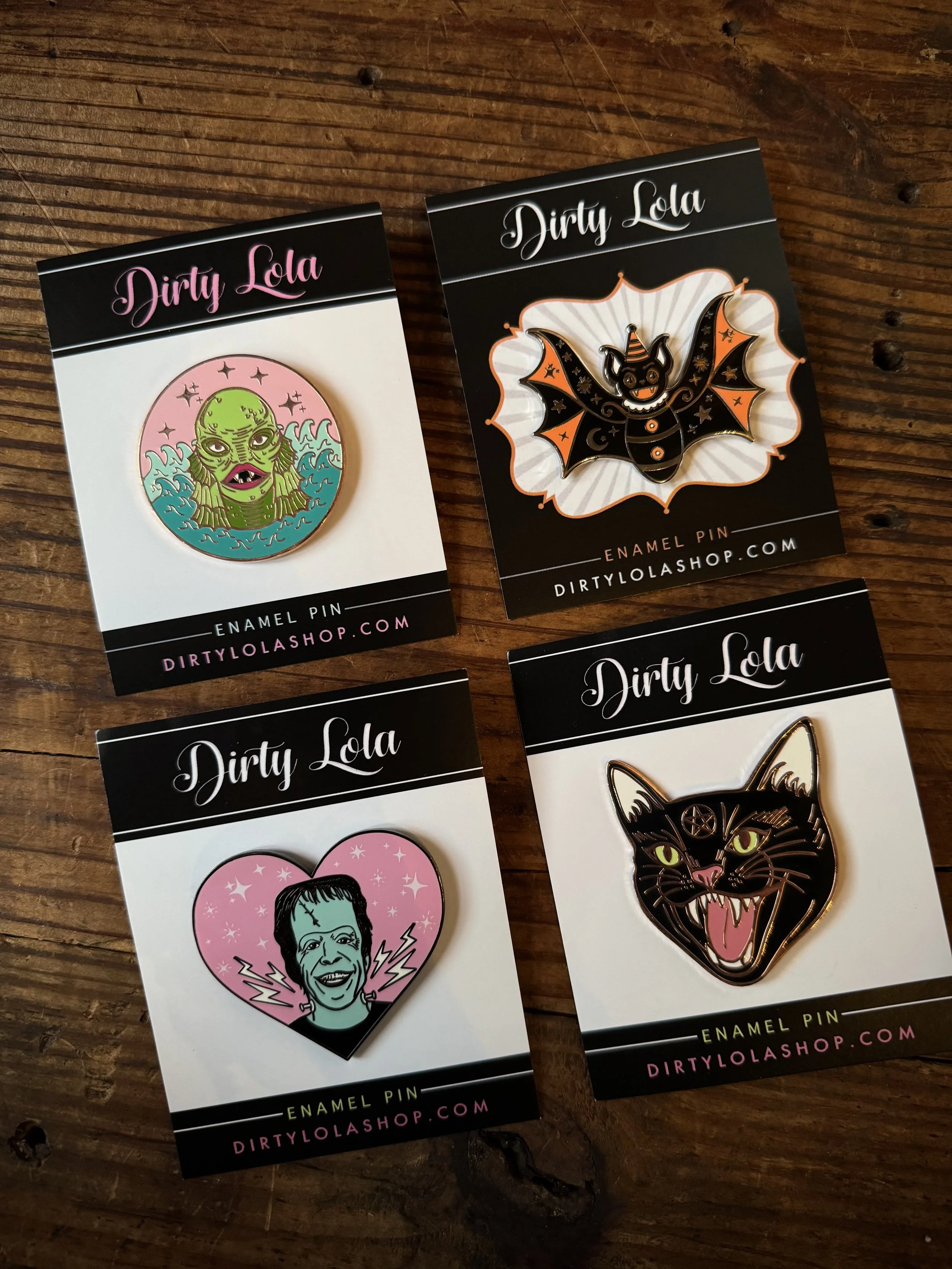 vintage halloween character inspired enamel pins: frankenstein, swamp thing, a halloween bat, and a black cat
