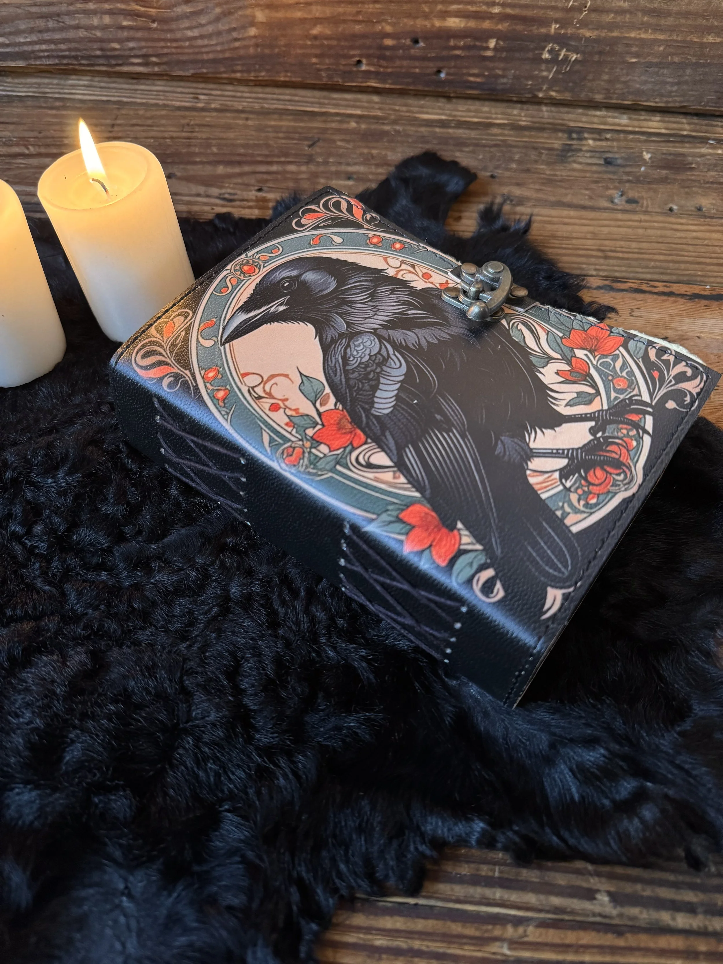 faux leather parchment paper journal with a large bol black raven on the front with green and red foliage
