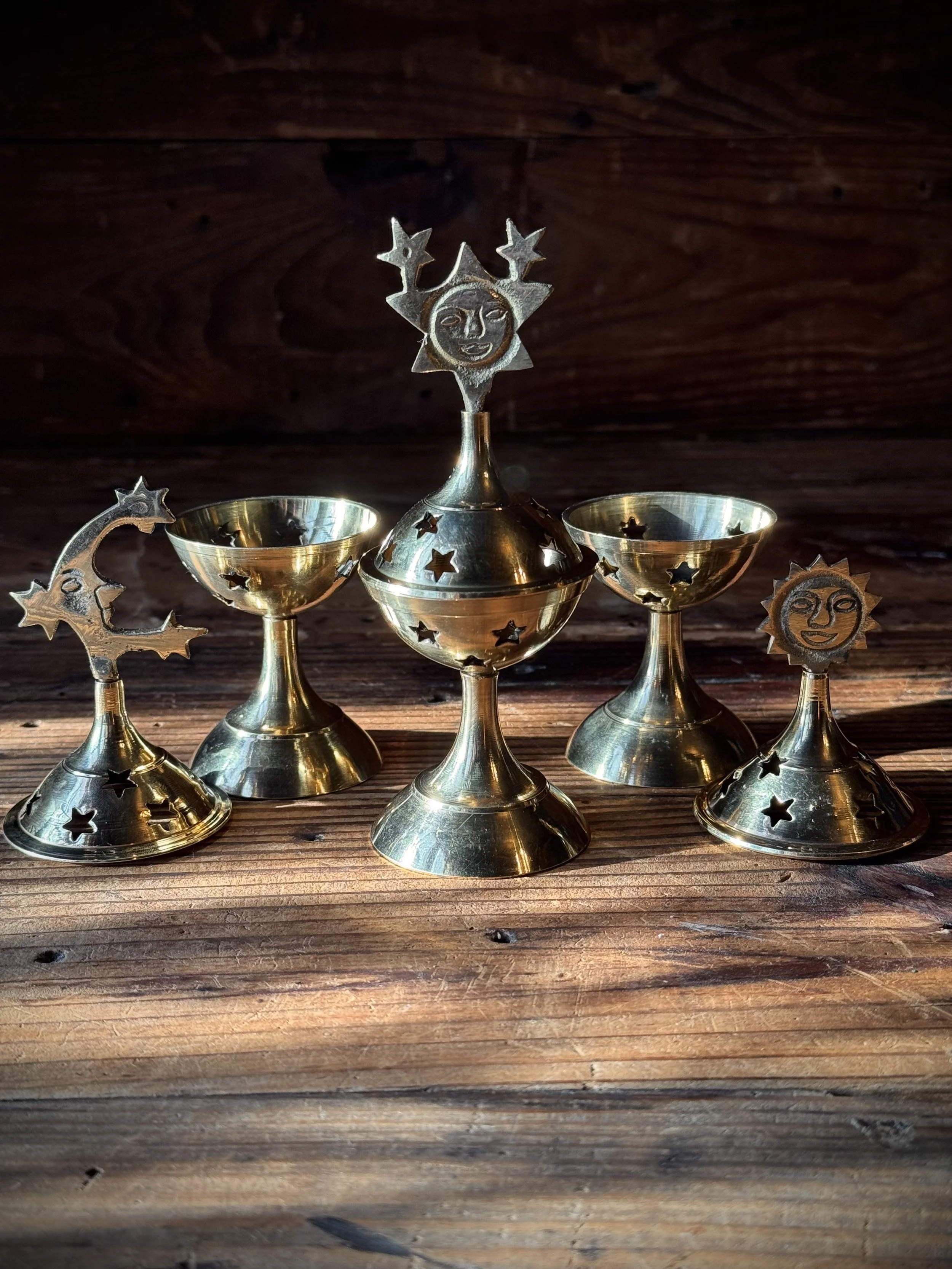 brass celestial cone incense burner with a removable top, cutout stars, and sun, moon, or star top decoration