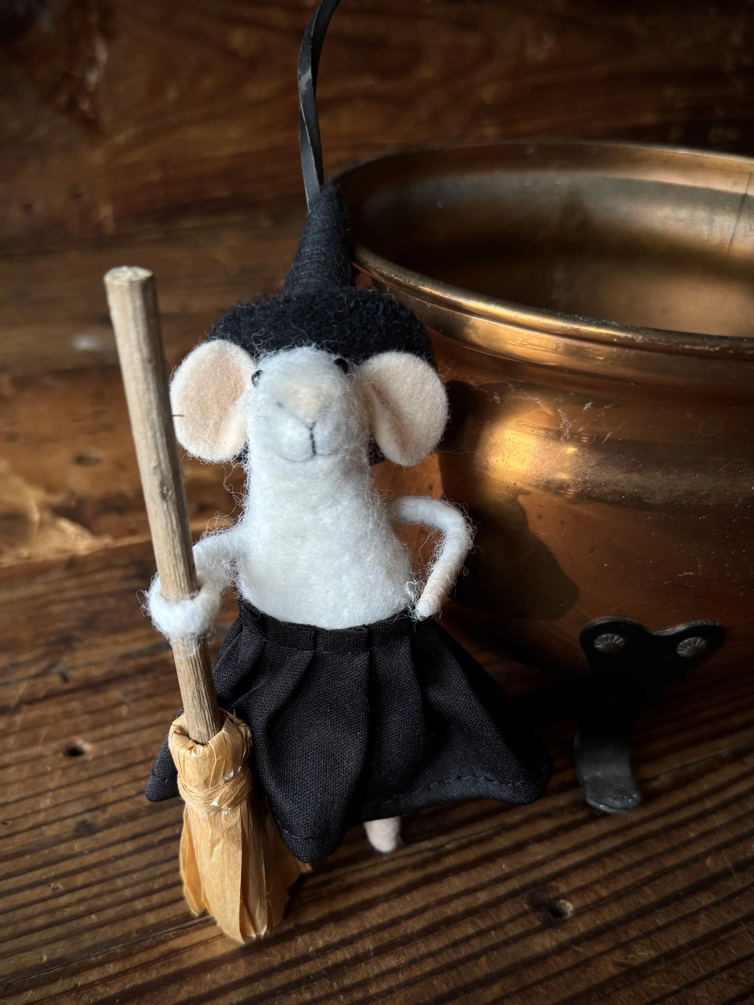 adorable felted mouse witch with a tiny witch hat and a tiny broom
