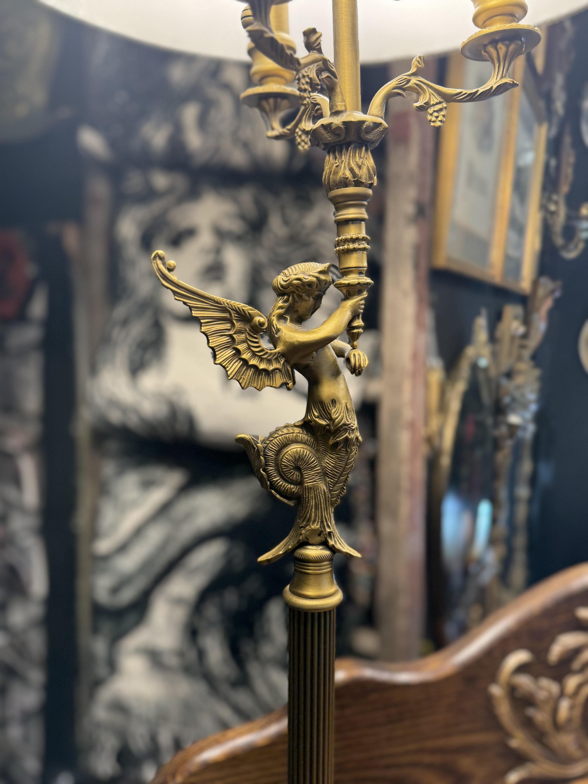 Antique gilded siren lamps with a white shade and a wooden base. Dual lightbulbs with pull chain.