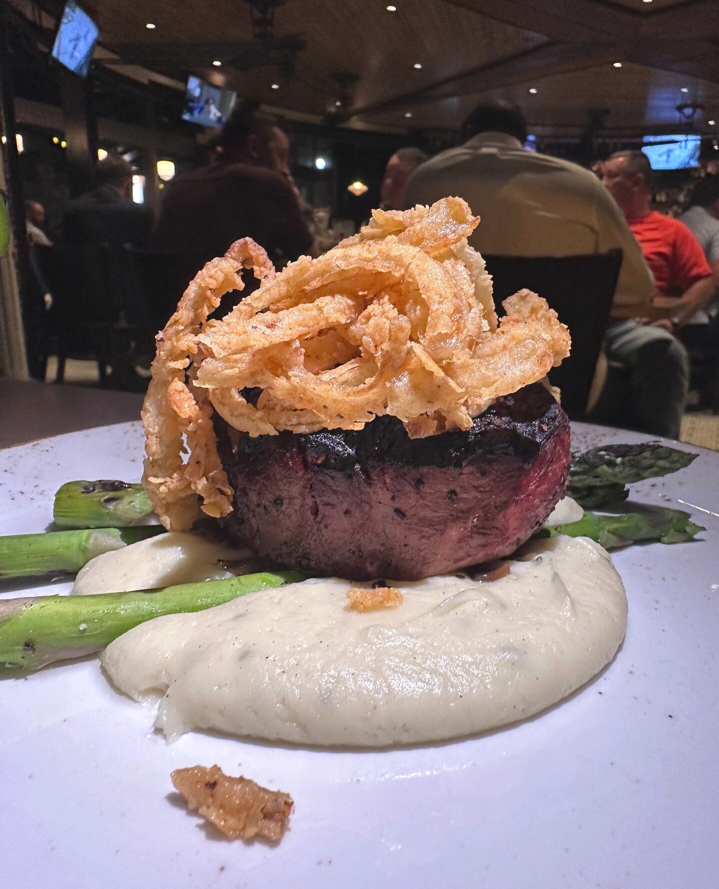 Get up close and personal with The Belle. 🔍️⁠
⁠
A flavorful filet cut, dressed in red wine-balsamic glaze, topped with fried onions, stacked on top of smooth chive-whipped potatoes, and perfectly grilled asparagus. ⁠
⁠
She's sure to be your favorite