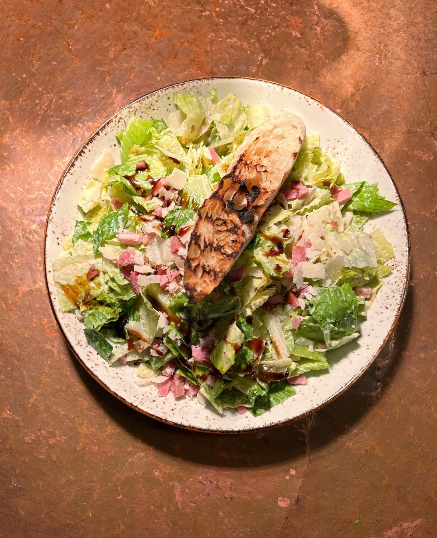 This is not your average Caesar salad! The New South Caesar is made with romaine, shaved country ham, parmesan, buttermilk Caesar, and blackstrap molasses, then topped with a crouton. It&rsquo;s plenty filling on its own, but also goes great with bla
