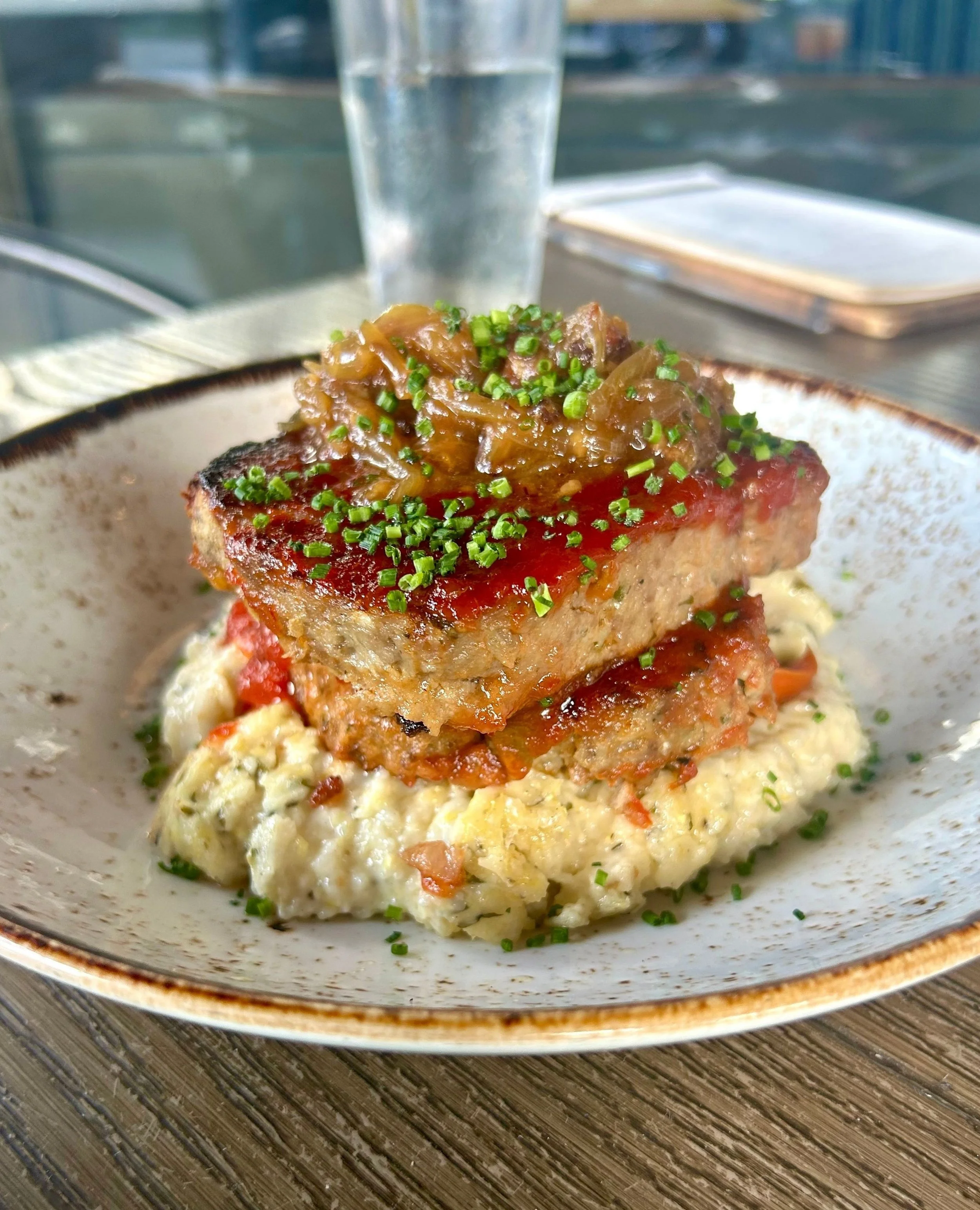 Meatloaf is southern comfort food at it&rsquo;s finest! 🍽️⁠
⁠
Our special recipe includes beef tenderloin covered in caramelized bacon jam, topped over smoked gouda herb grits and maple glazed carrots. ⁠
⁠
#southerncomfortfood #meatloaf #nashvillefo