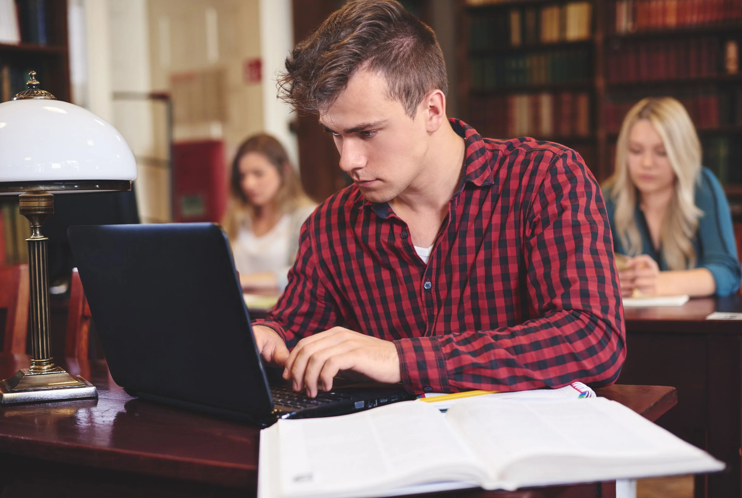 Adult practicing phonics lesson with notebook and computer