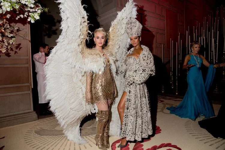 Katy Perry (left) in Versace; Rihanna (right) in Maison Margiela; Credit to Kevin Tachman/Getty Images for Vogue