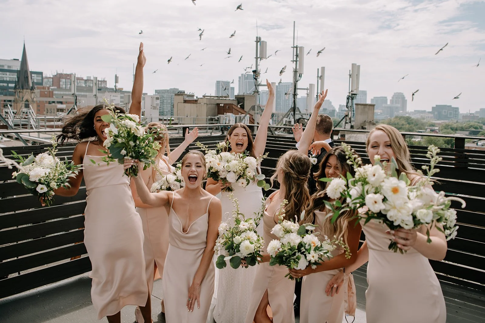 Kaitlin + Ethan - Their wedding party in dresses plus the bride and groom jumping with their bouquets, The Burroughs, Toronto Wedding florist