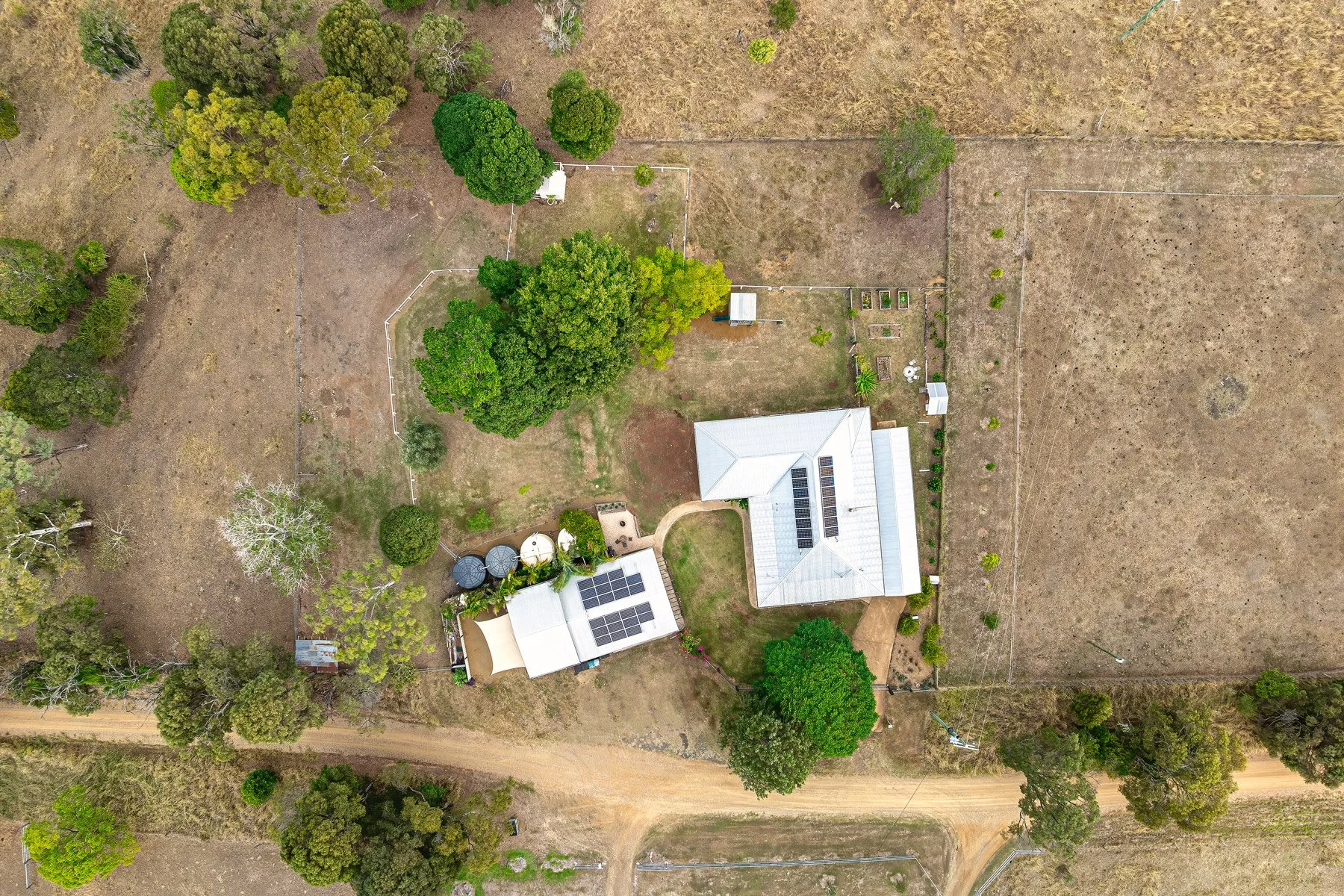  Aerial view of acreage property with white home, shed and established trees — drone photography SEQ by Digital 1 QLD 