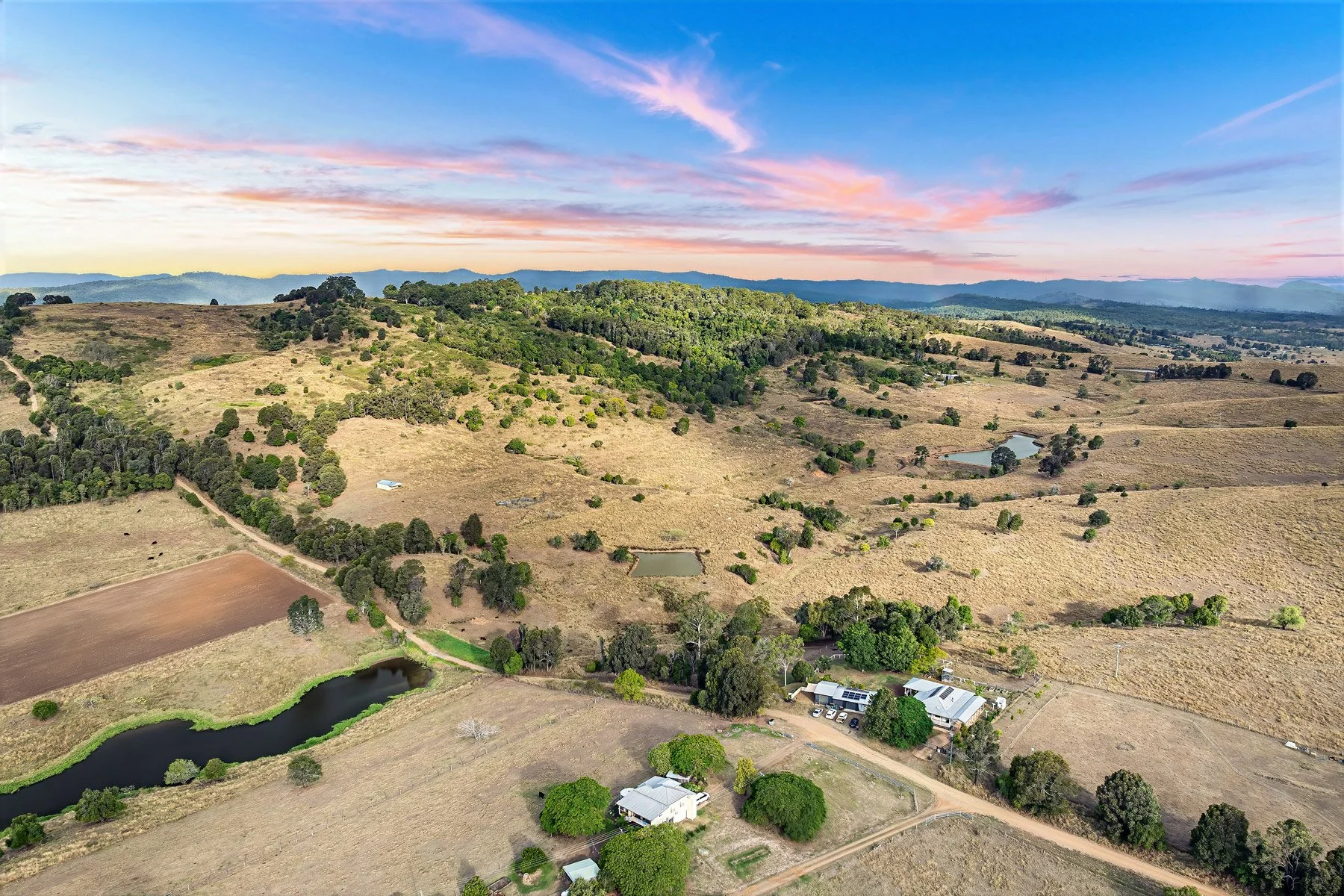  Wide aerial panorama of rural landscape at dusk with pink and blue sky — aerial property photography South East Queensland 