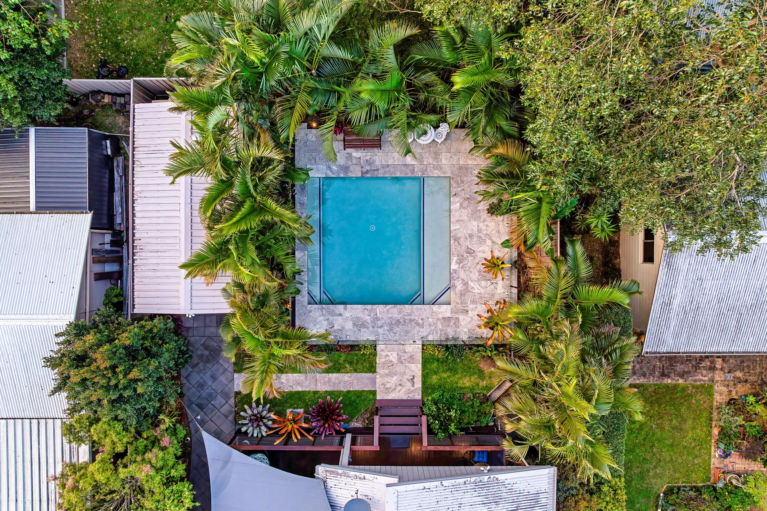  Top-down aerial of pool, entertaining area and lush garden surrounds — aerial property photography Gold Coast 