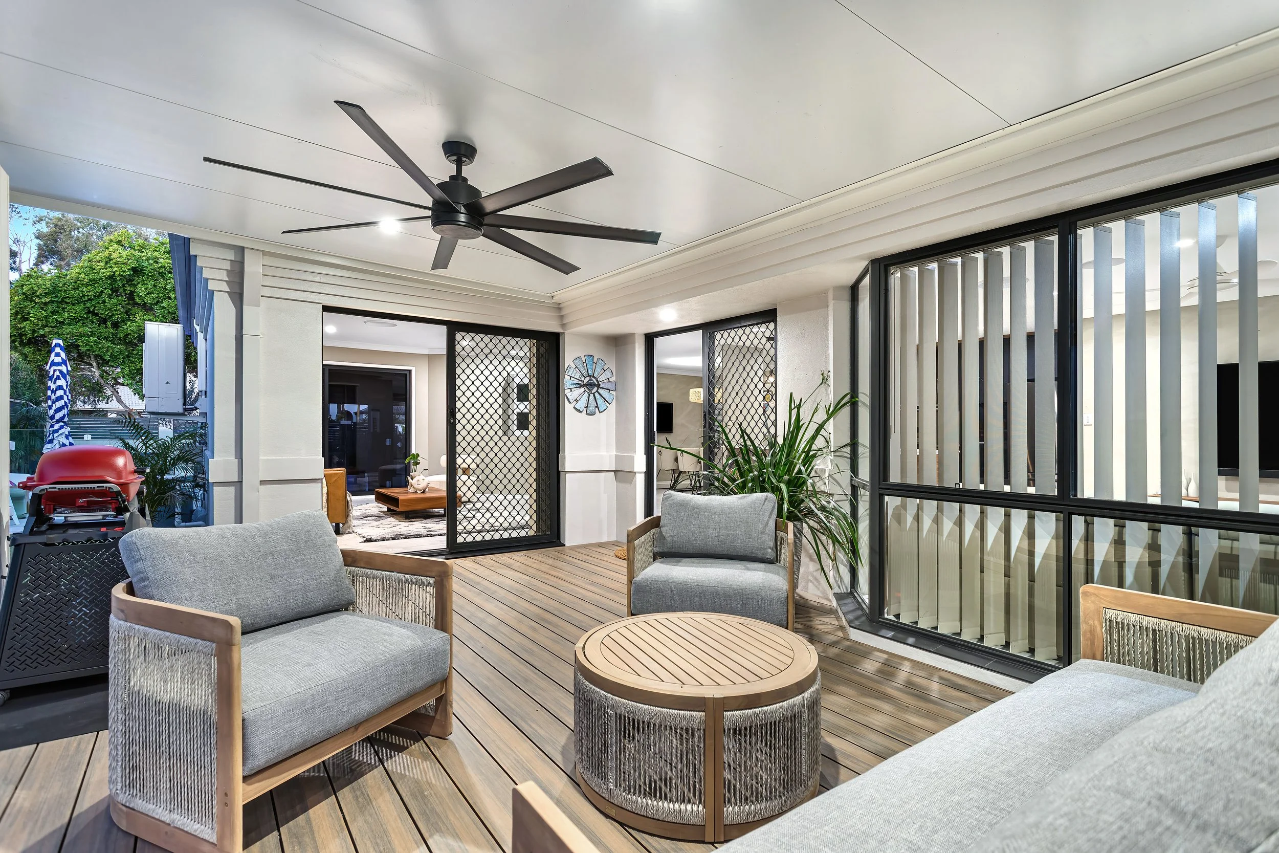  Covered alfresco patio at 13 Zac Avenue, Coombabah with outdoor lounge seating and a large ceiling fan 