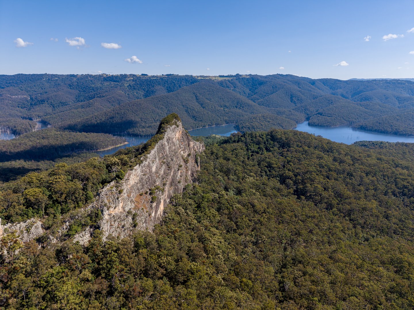Aerial drone photography showcasing rocky mountain peaks and lush bushland in Advancetown QLD