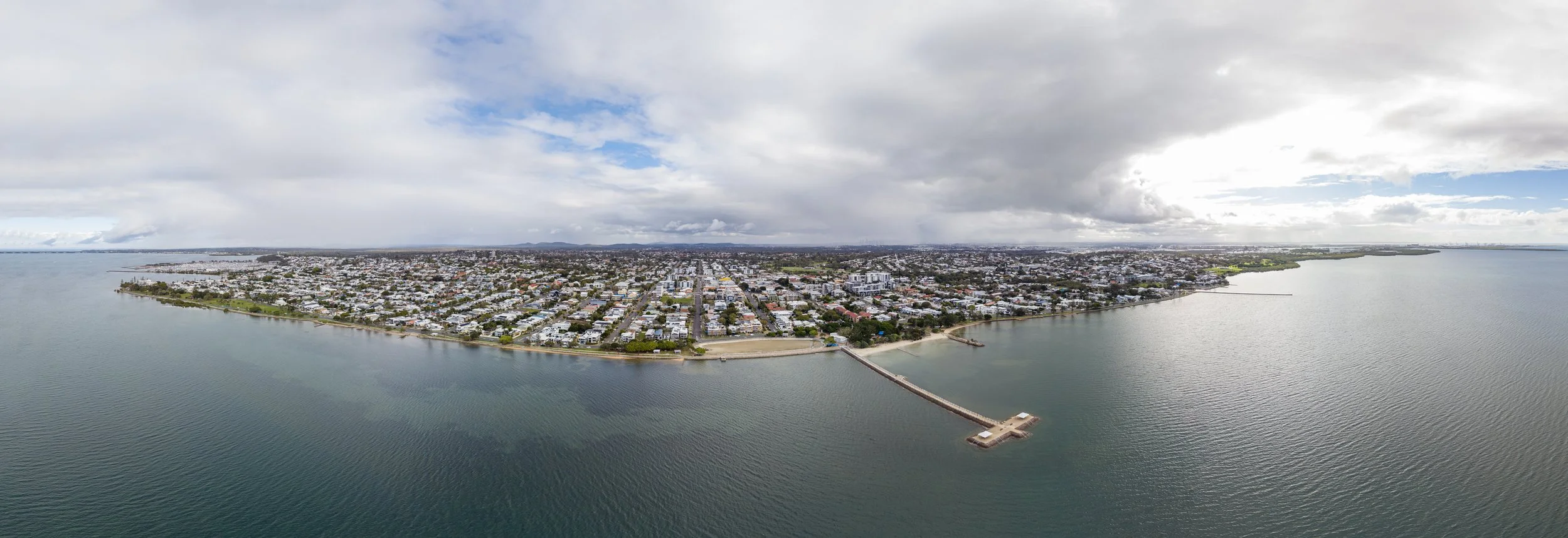 Aerial drone panorama of Wynnum QLD showing the suburb peninsula, Moreton Bay and jetty — Digital 1 QLD real estate drone photography, Brisbane East
