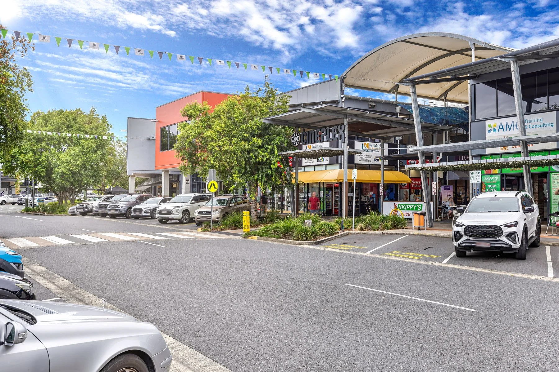 Outdoor pedestrian walkways and local commercial shopping complexes in Victoria Point QLD, showcasing everyday local business infrastructure and convenience amenities for a suburb profile gallery page.