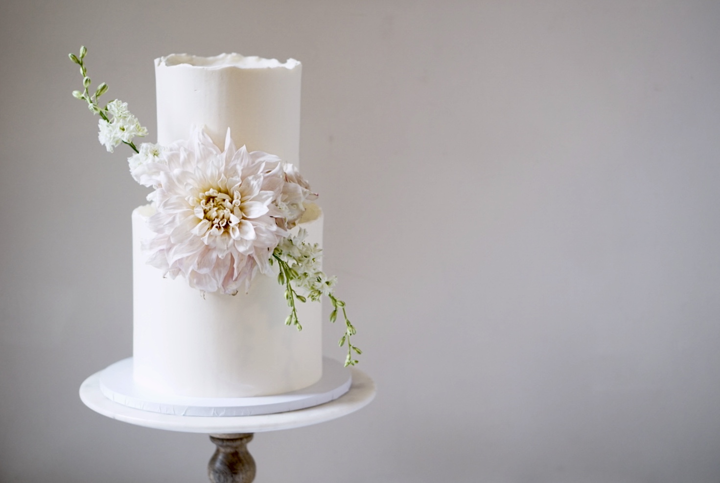 Soft pink dahlia buttercream two tier wedding cake