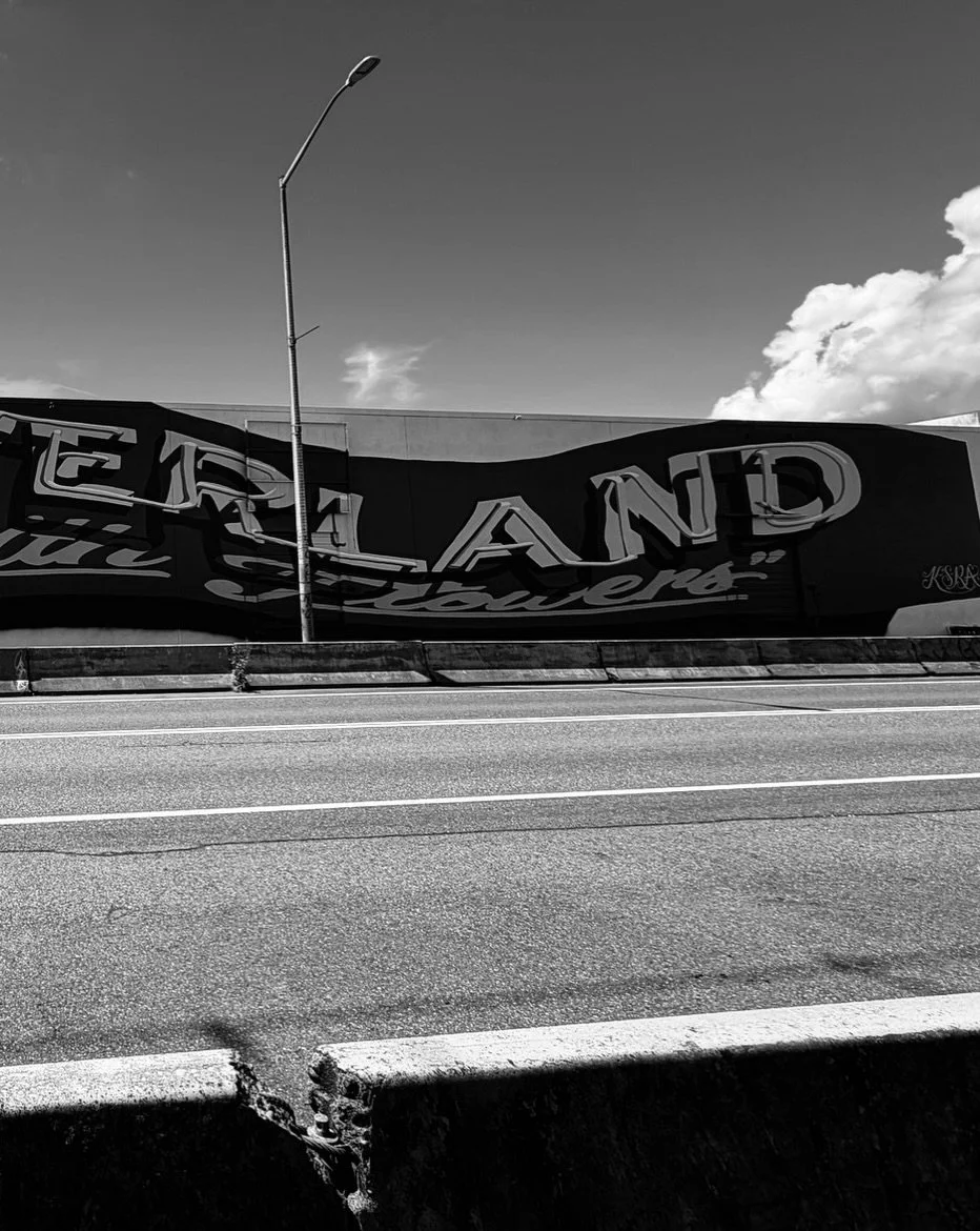 (1/2) flowerland neon mural by @ksra_ksra spanning 200 feet of track in #sodo 🛤️ sara is proving she knows no bounds in regards to scale: she started by making a wooden *miniature* of this historic sign and ambitiously proposed that she take it to t