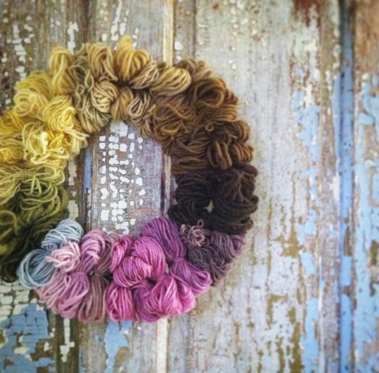 Naturally dyed wreath 🌸🌿🌺Years ago, I created this wreath with naturally dyed yarn samples. 
When I was new to natural dyeing, I was so excited to try anything that would create a color, even when advised it may not be colorfast (i.e., black beans