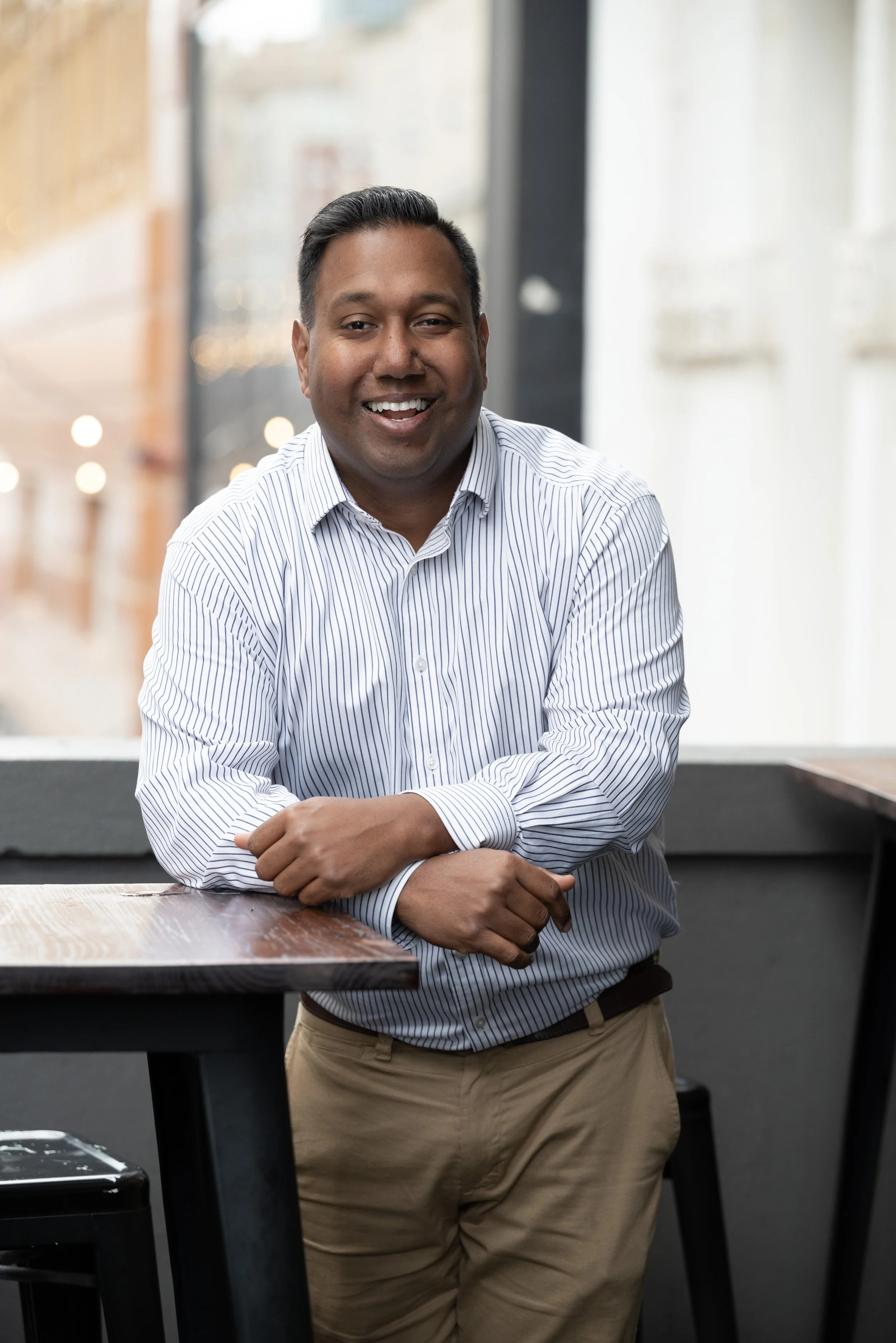 Mark Winter leaning on a table and smiling