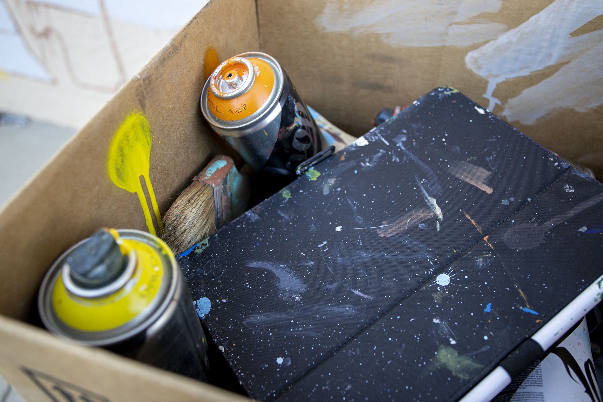  Juan Pablo Reyes' materials, which include spray cans, brushes, and an iPad on February 25, 2022 in Pacoima, Calif. 