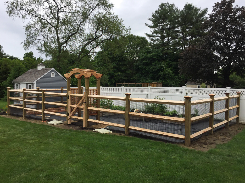 post and rail garden fence with arbor in Bedford