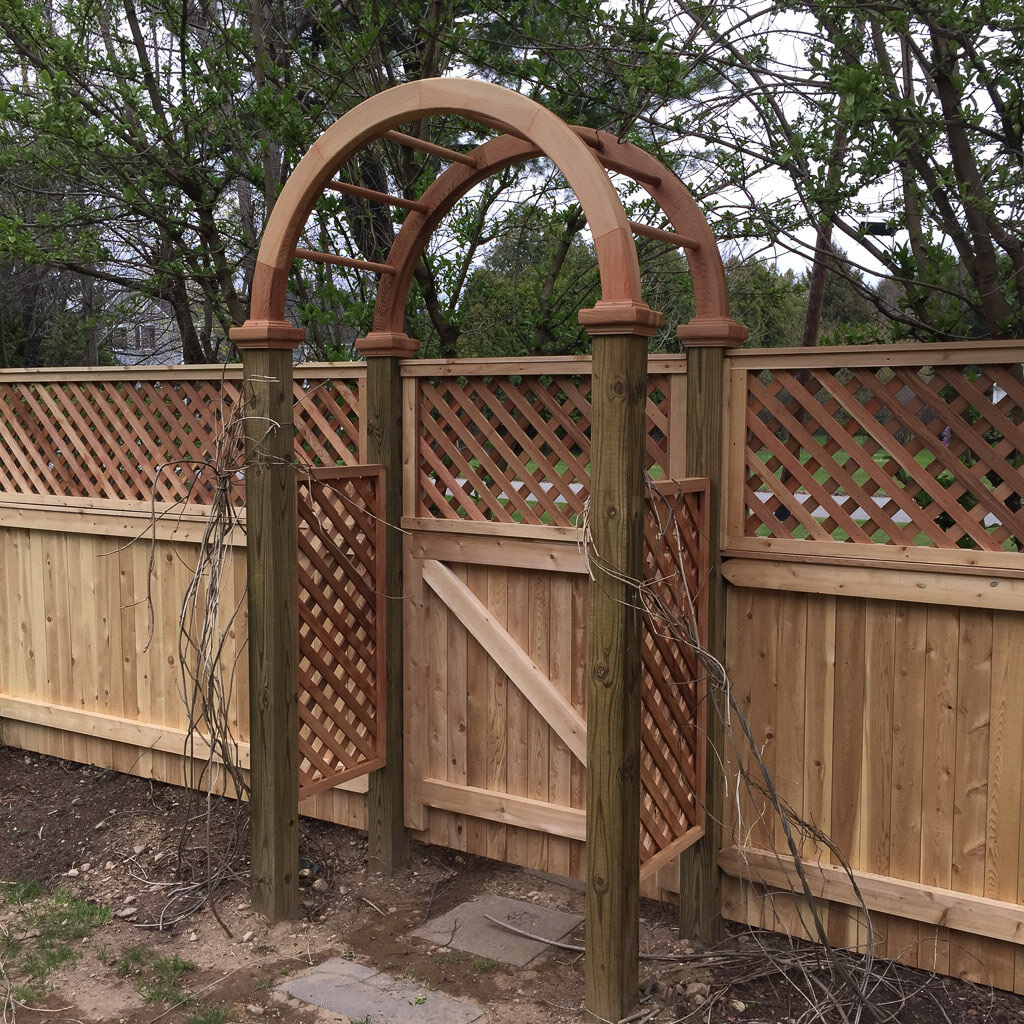 cedar arbor with board and lattice fence