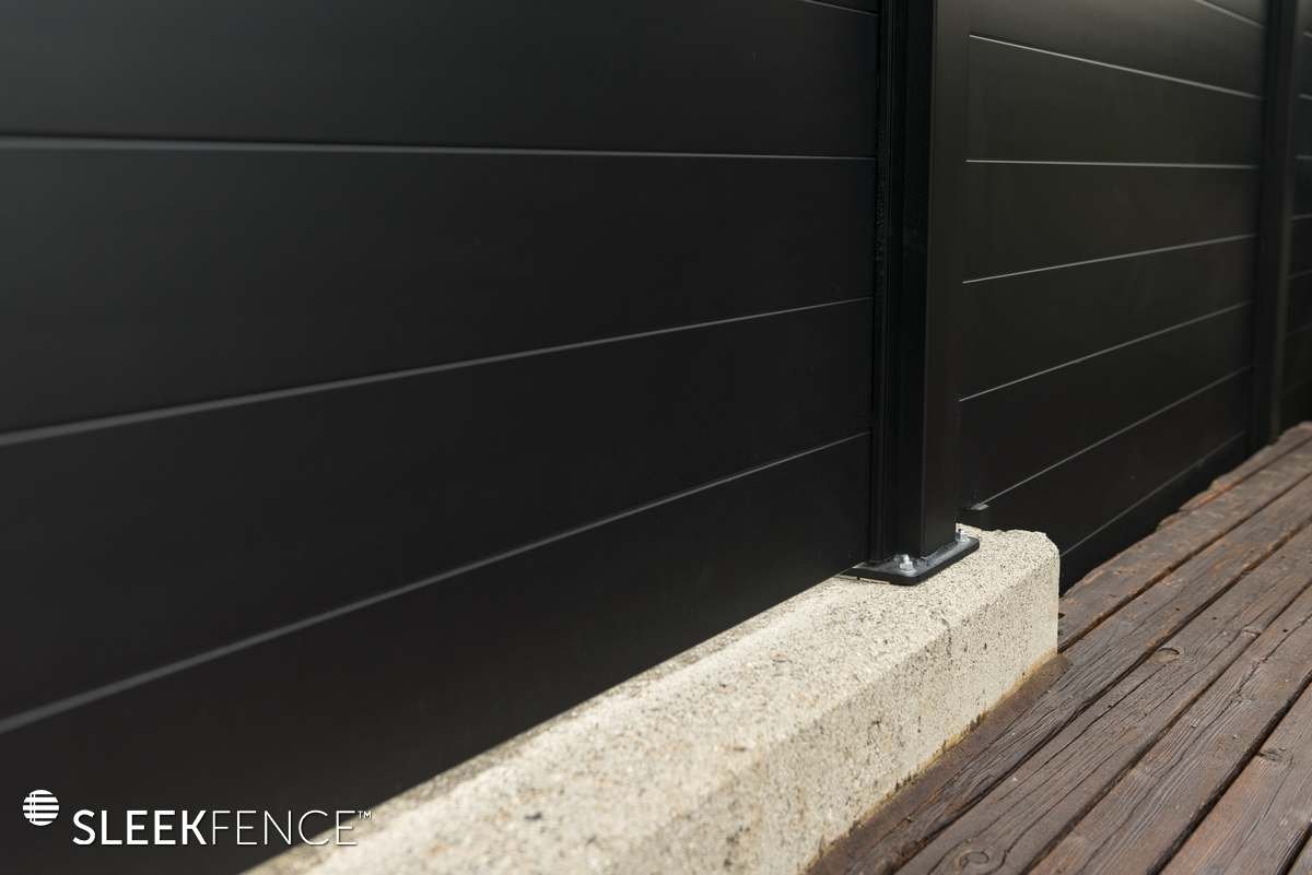 Sleek privacy fence on concrete wall.jpg