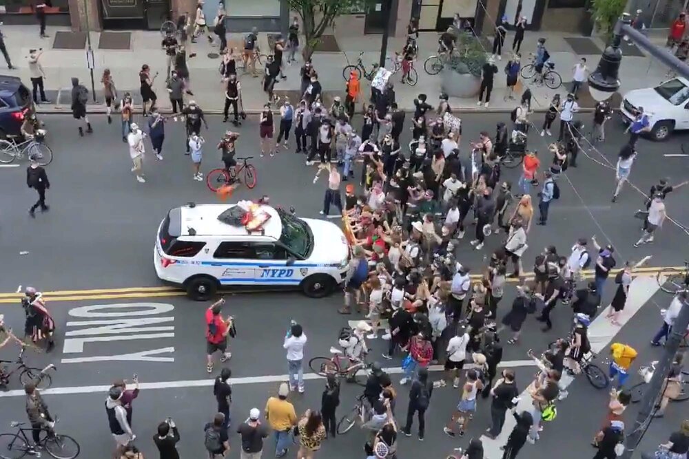 A clip from a viral video of two NYPD SUVs ramming into a group of protesters in Brooklyn.