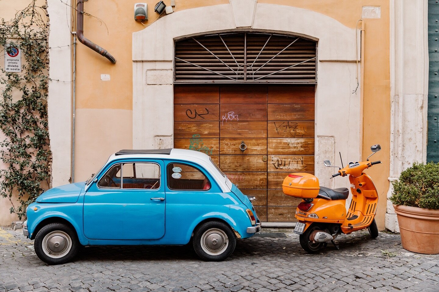 I always come back to this shot from a trip through Rome. The real grunge scenery and pop of two vehicles my American sensibility found quaint. Just charming.