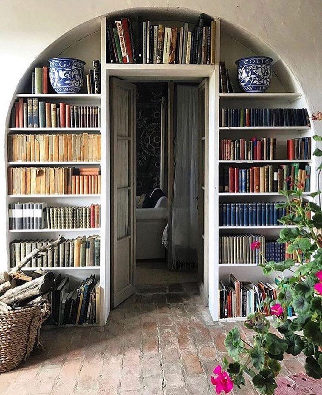 Everything about this says &quot;Happy Place&quot; ...Arches always feel welcoming to me... the books look like they've been actually read, there's a basket of wood for a fire...the plant life..... this is the kind of life I want to live 👌
