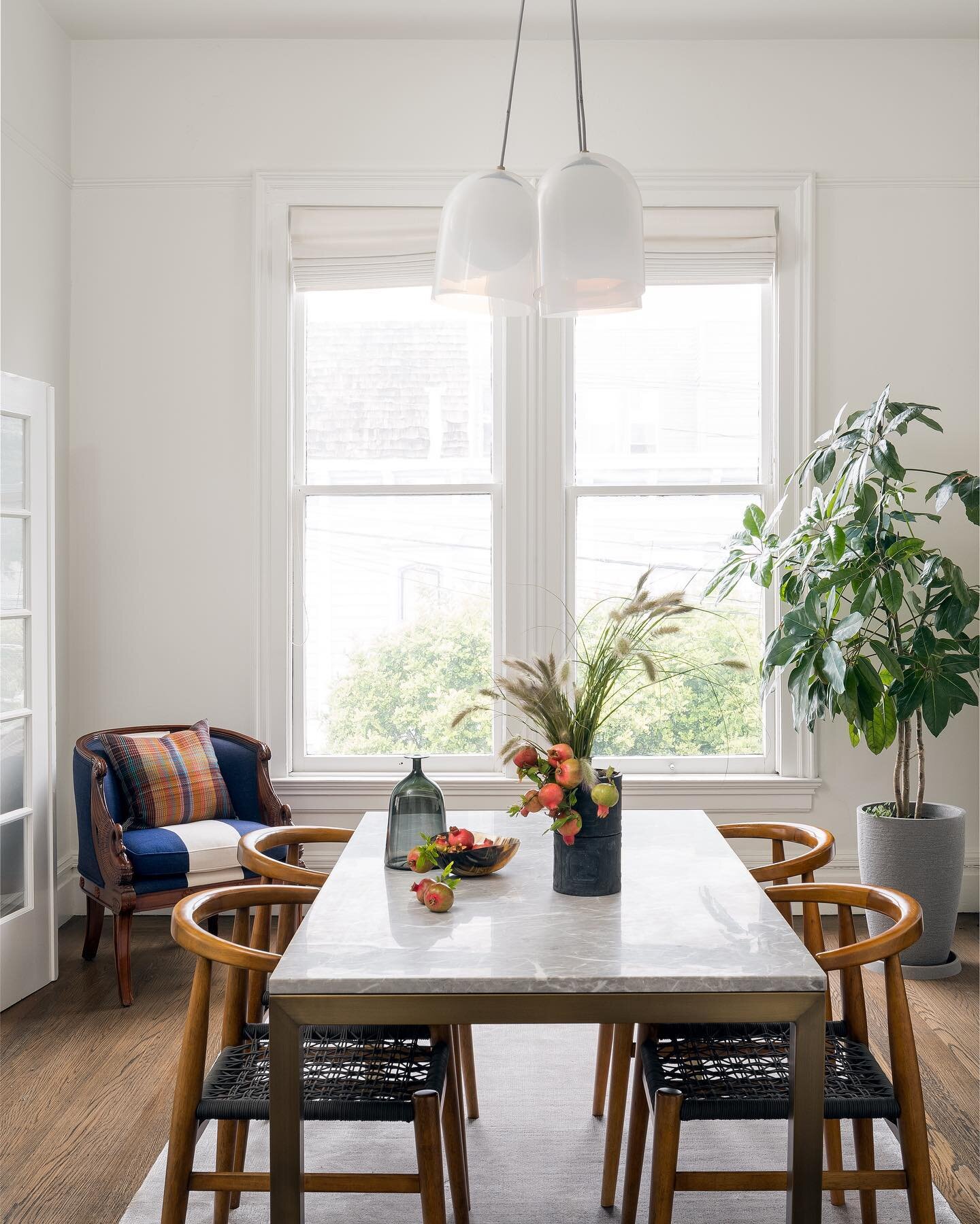 Another shot of our San Francisco dining room!⁣⁣
⁣⁣
I had a wood dining table here but it was getting destroyed by the sun. These are original windows from the 1850s &amp; they have zero UV protection, so I replaced it with a stone dining table.⁣
⁣
F