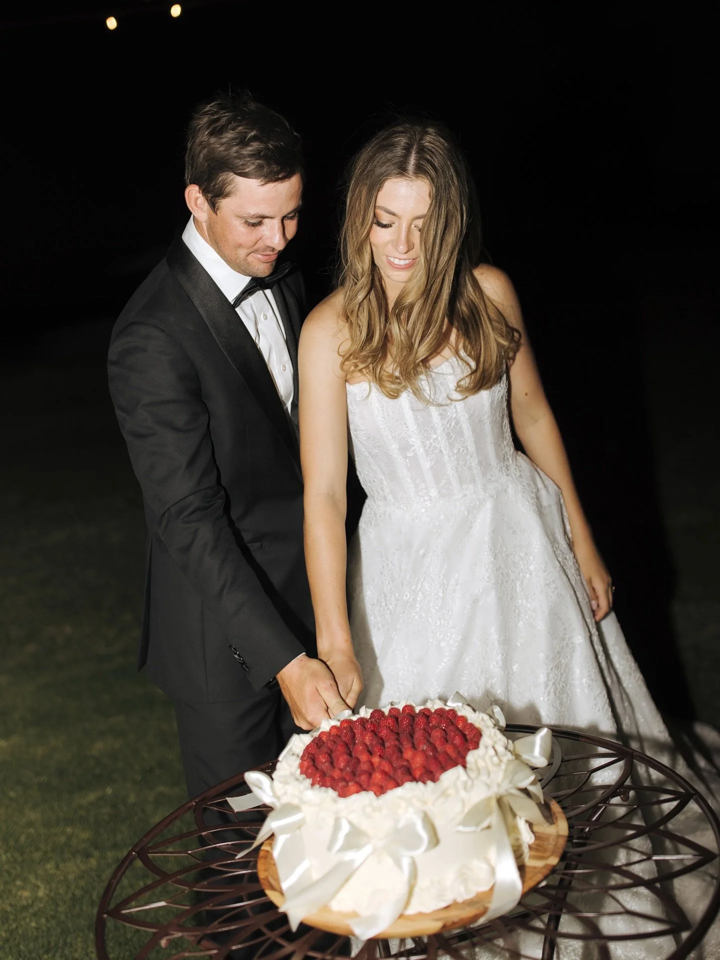 Created by a little country bake house, this raspberry topped cake lined with satin bows was a delightful addition to Lindsay and Jake&rsquo;s evening. Such a fun day!