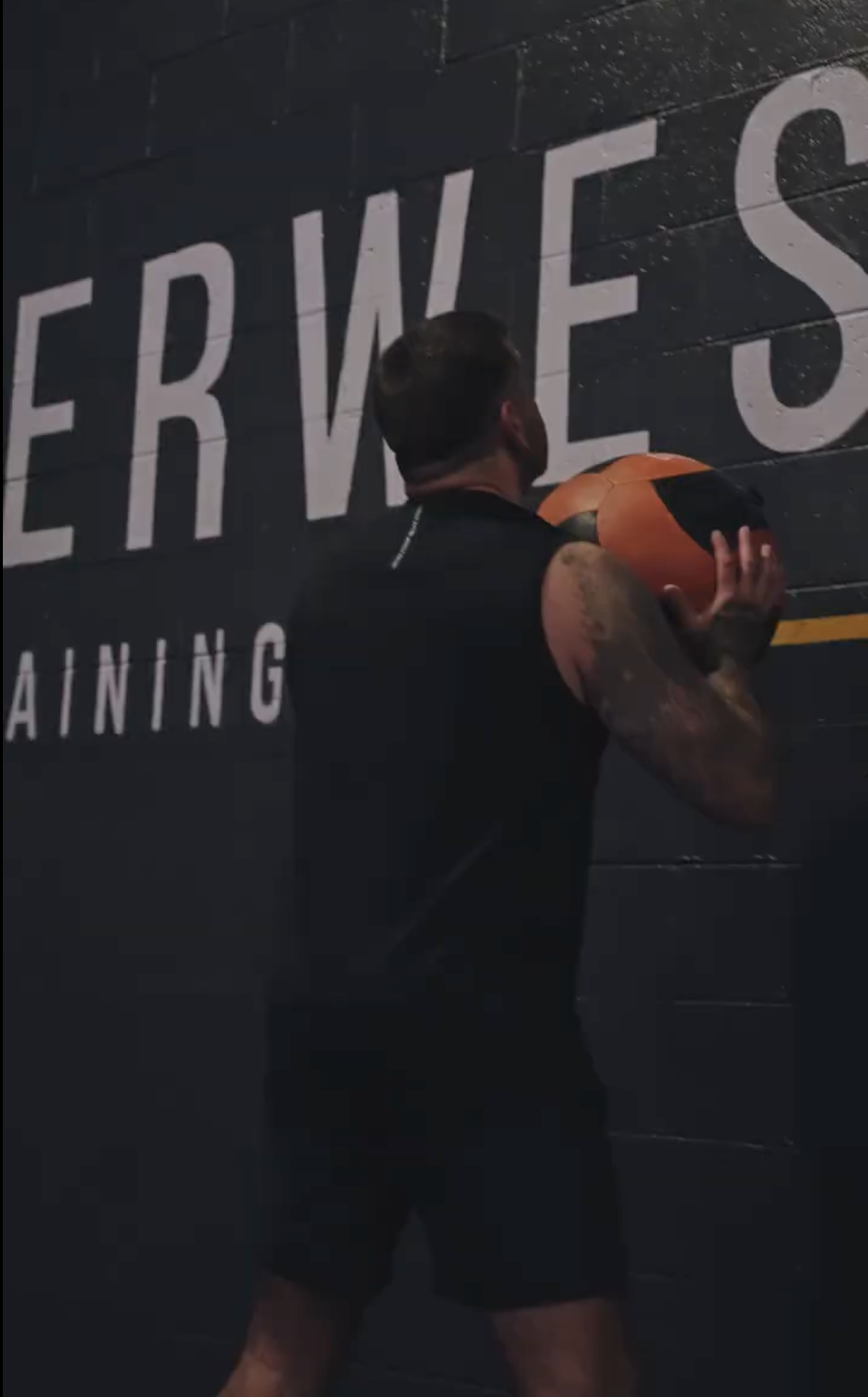 Member throwing a wall ball in the gym