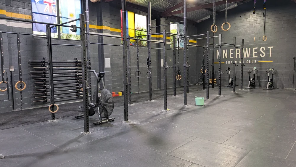 The empty gym floor with rigs and bikes
