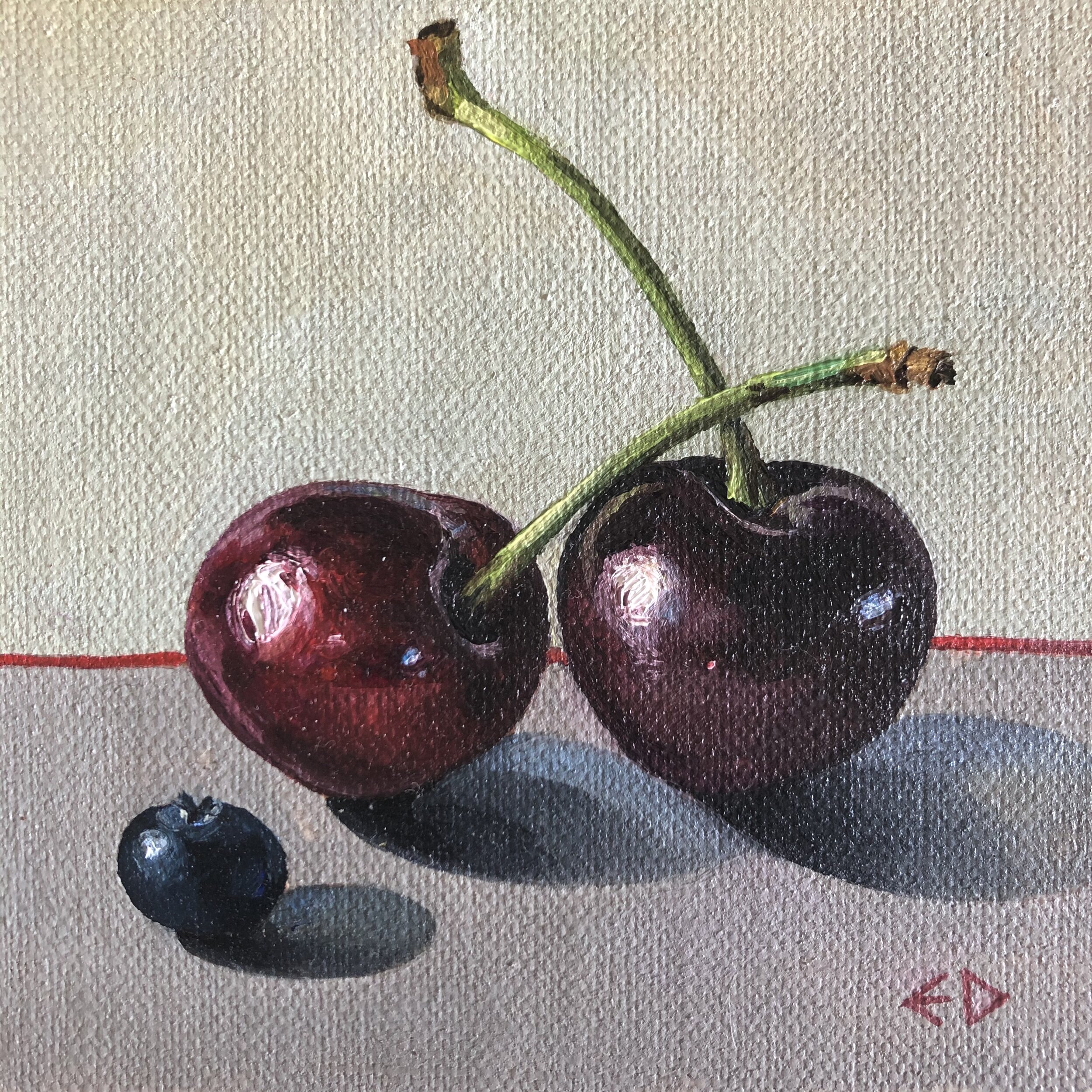 Two cherries and a blueberry
