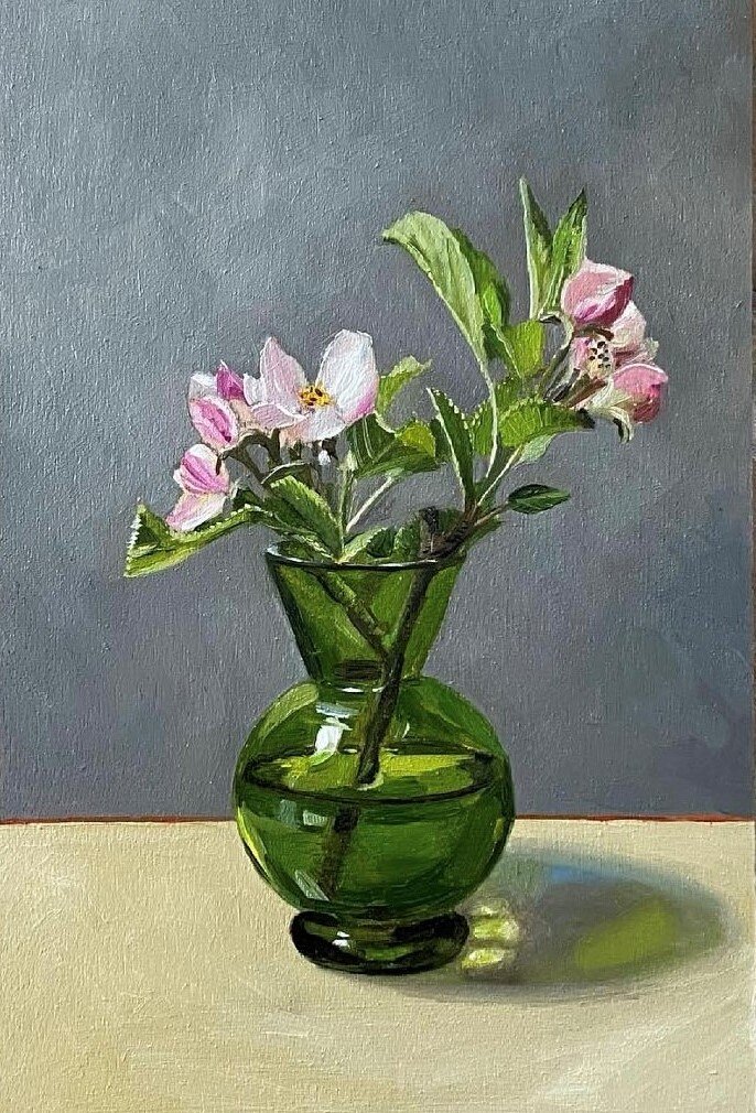 Green vase with apple blossom