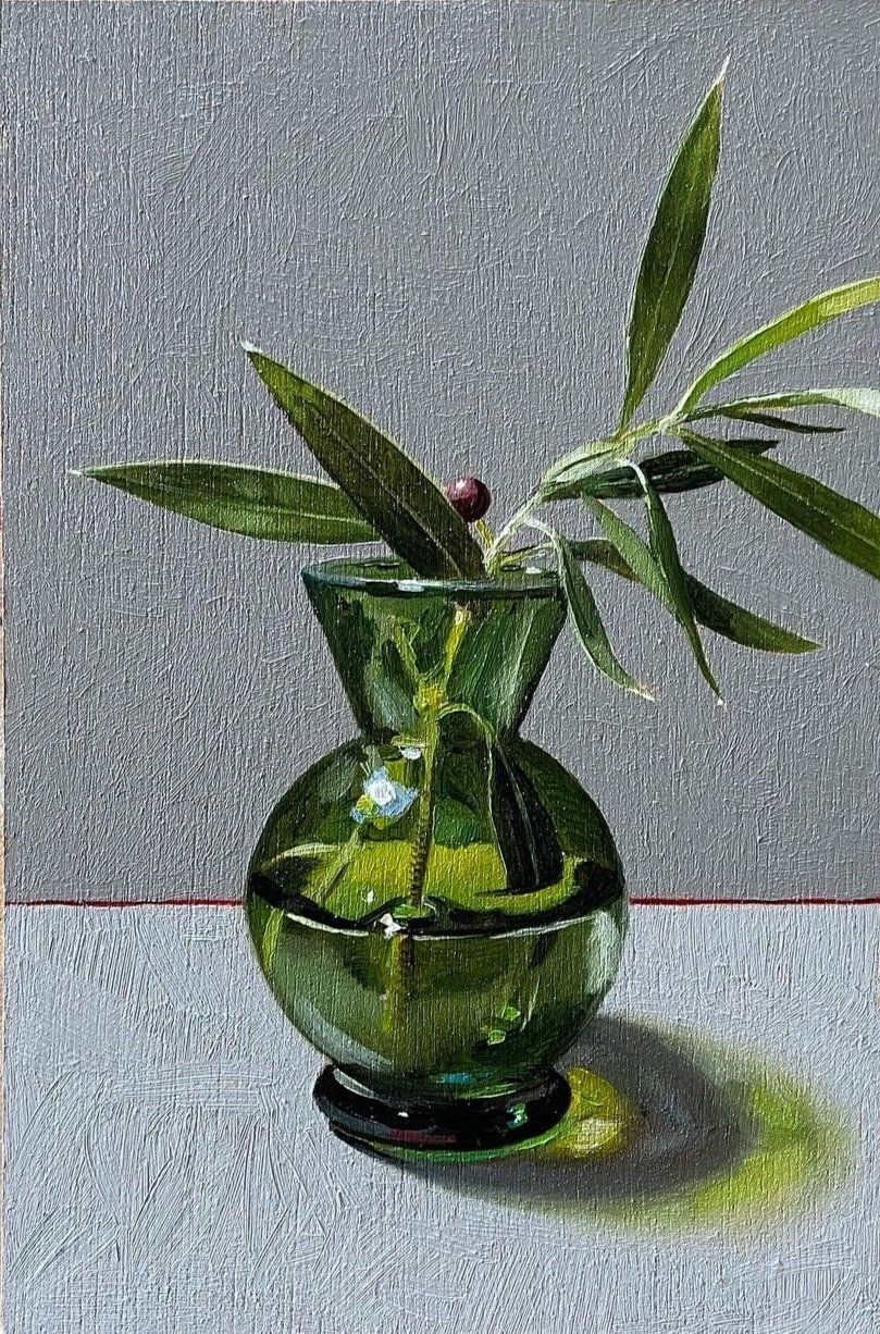 Green vase with olive sprig