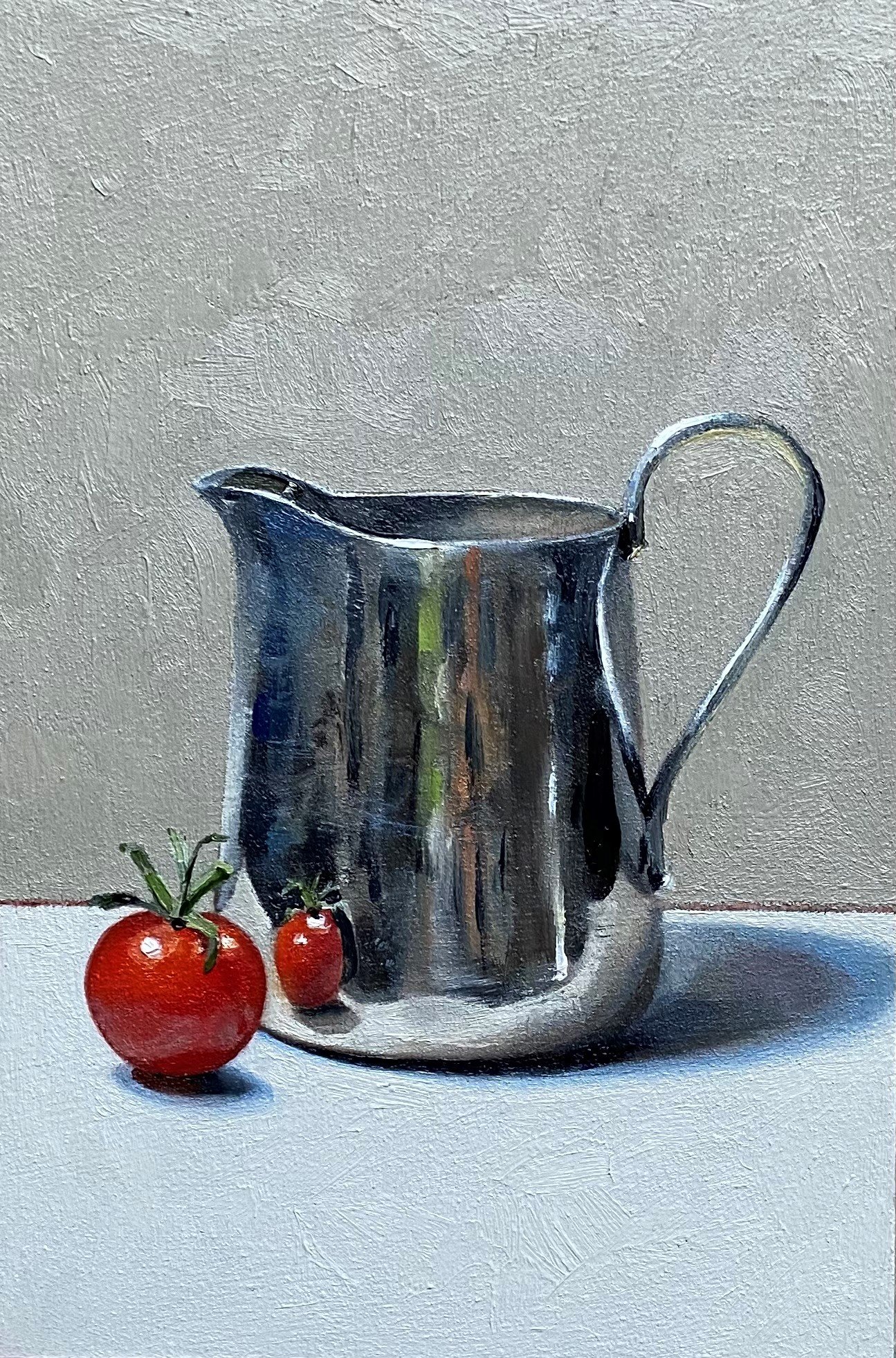 Silver jug with little tomato