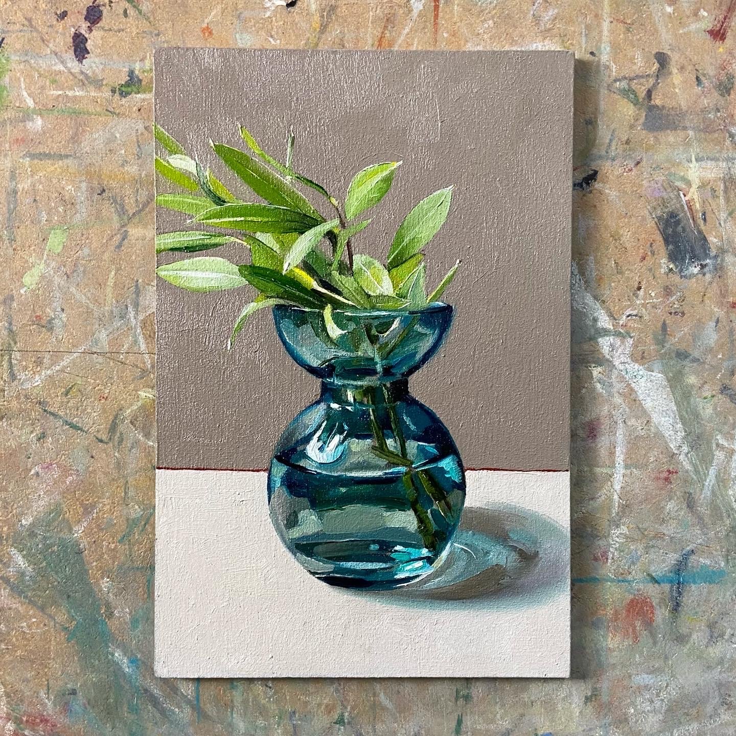 Blue vase with olive sprig