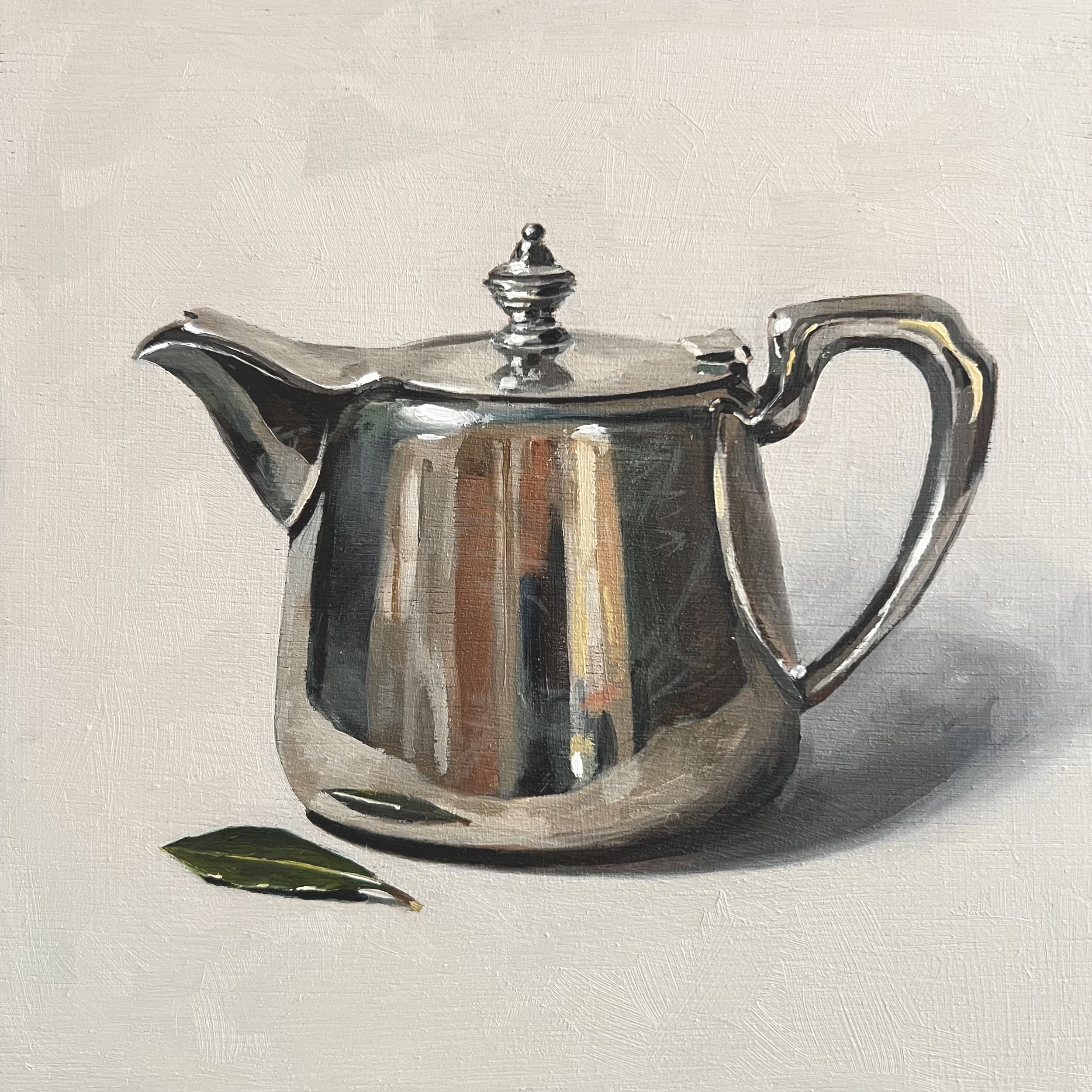 Silver teapot with bay leaf