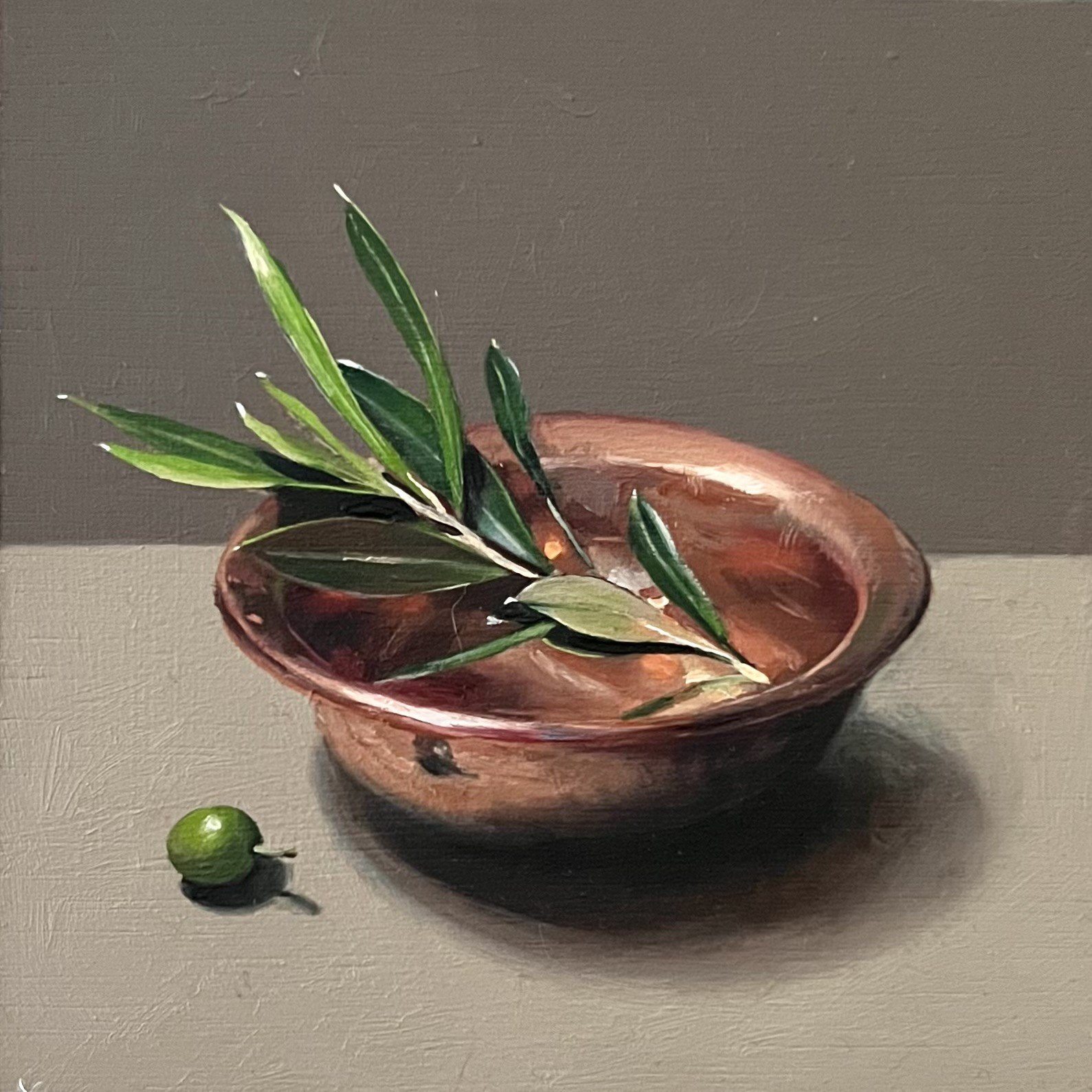 Olive sprig in copper bowl
