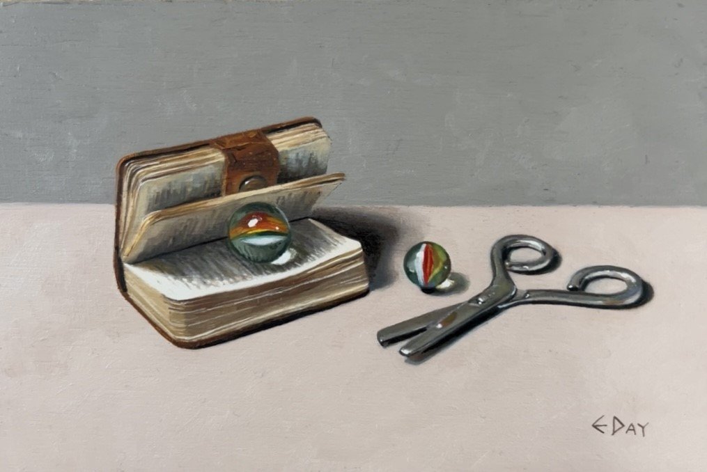 Book with marbles and scissors