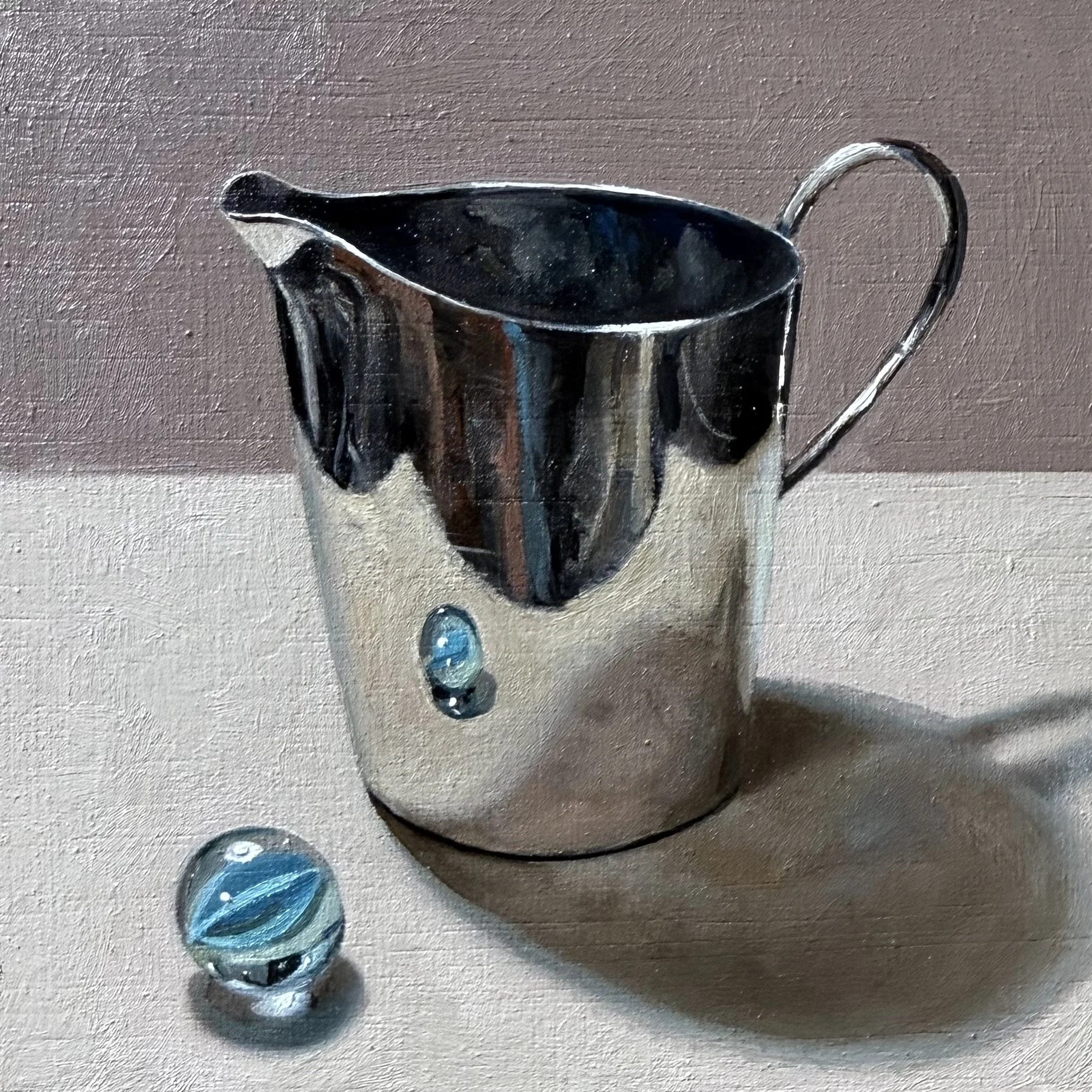 Silver jug with blue marble