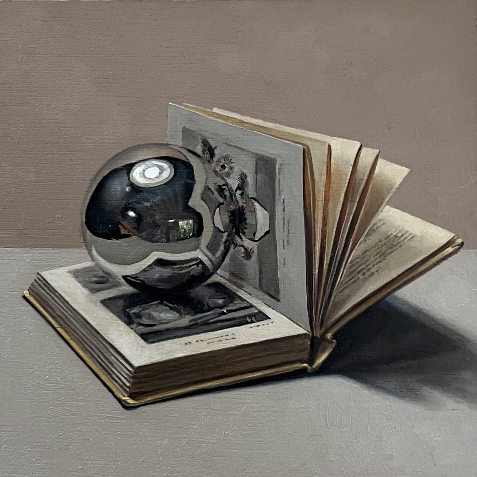Silver ball with art book