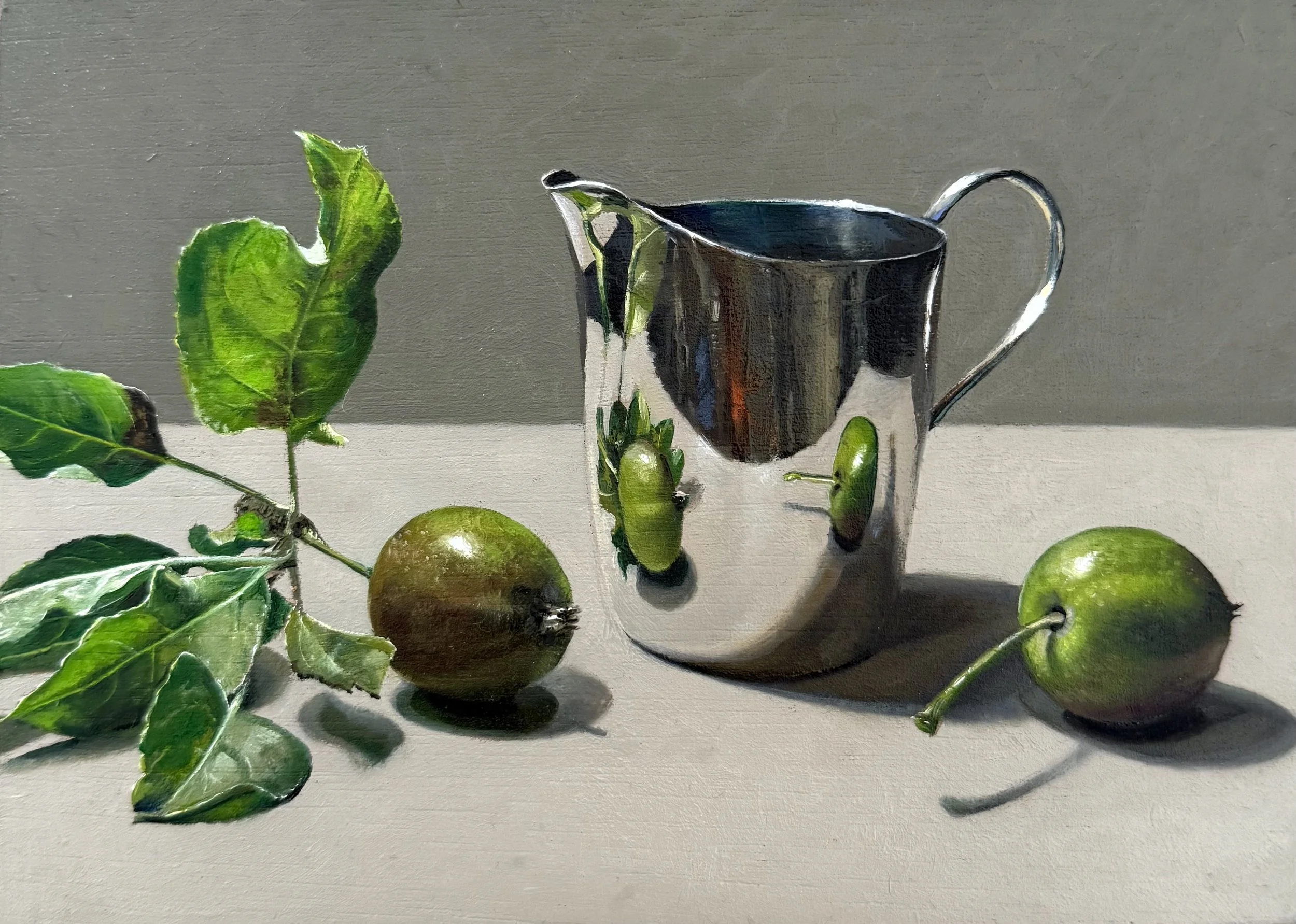 Silver jug with baby apples