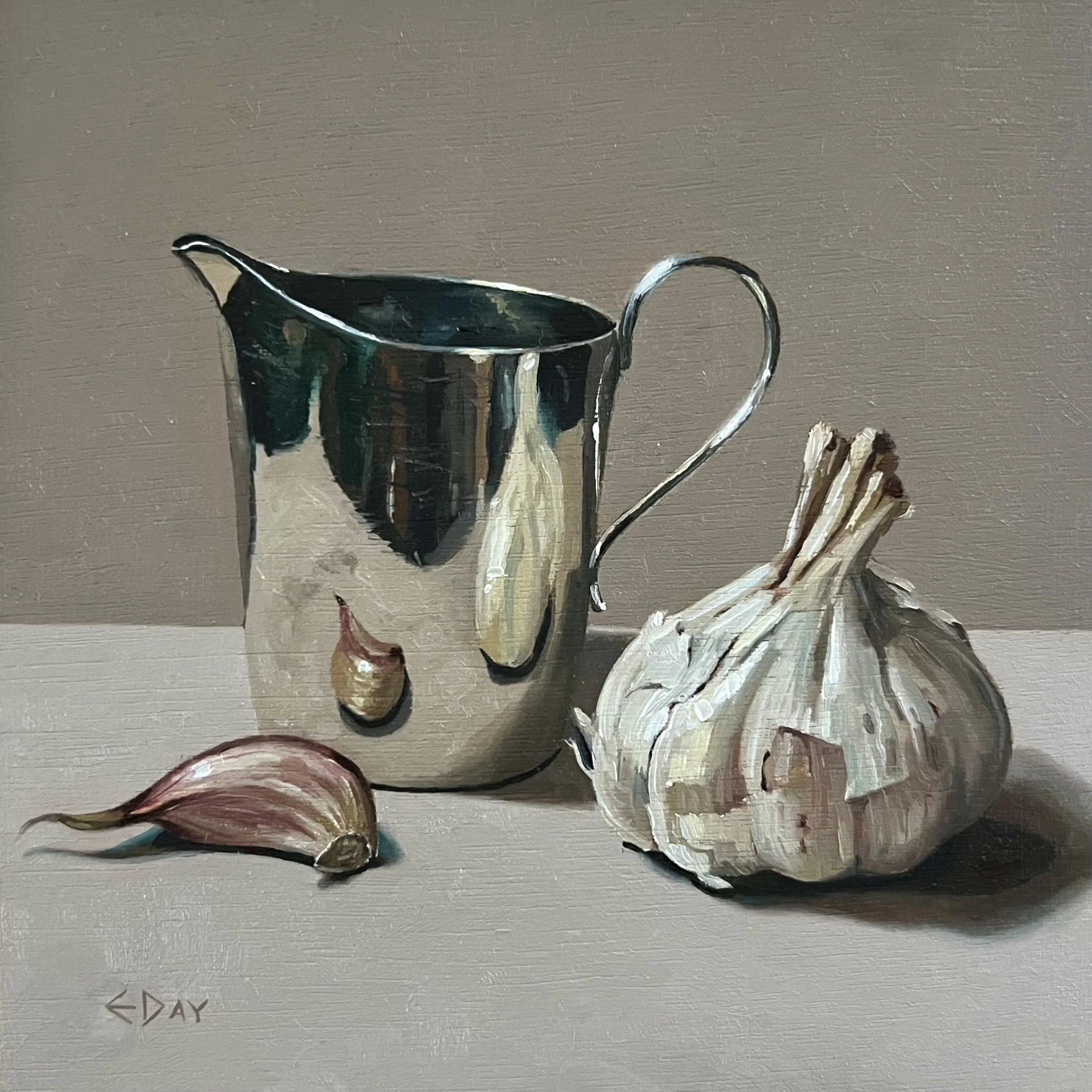 Silver jug with garlic bulb