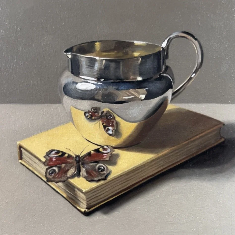 Silver jug with butterfly