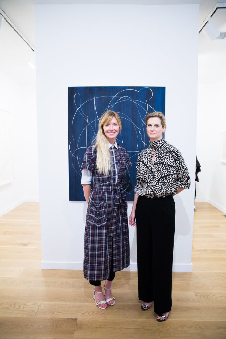 Photo by Ariana Clare; SOCO Gallery founder Chandra Johnson (left) and artist Elliott Puckette in front of her painting, Blue Ridge Parkway.
