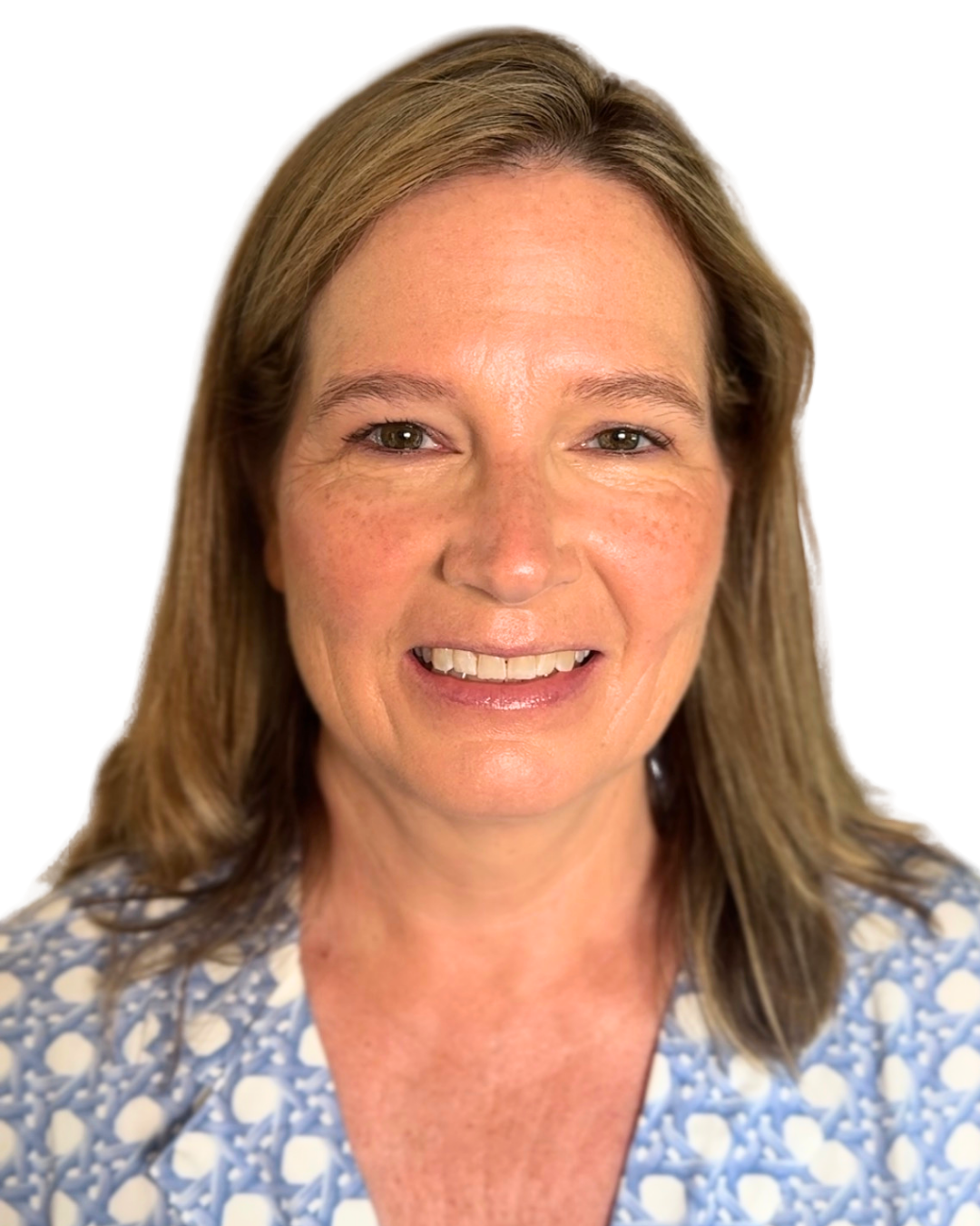 A woman with light brown hair smiling at the camera, wearing a blue and white patterned top.