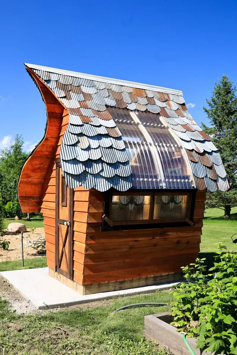 whimsical-garden-shed-with-curved-roof.webp